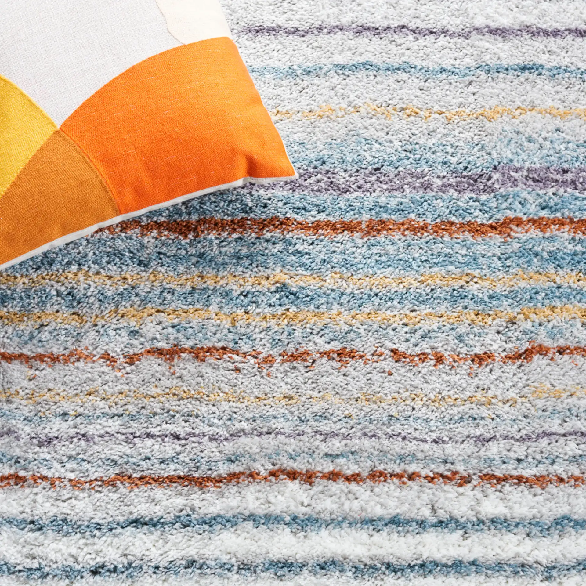 Berber Gradient Stripe Shag Rug in Blue Rust / Ivory in a styled room