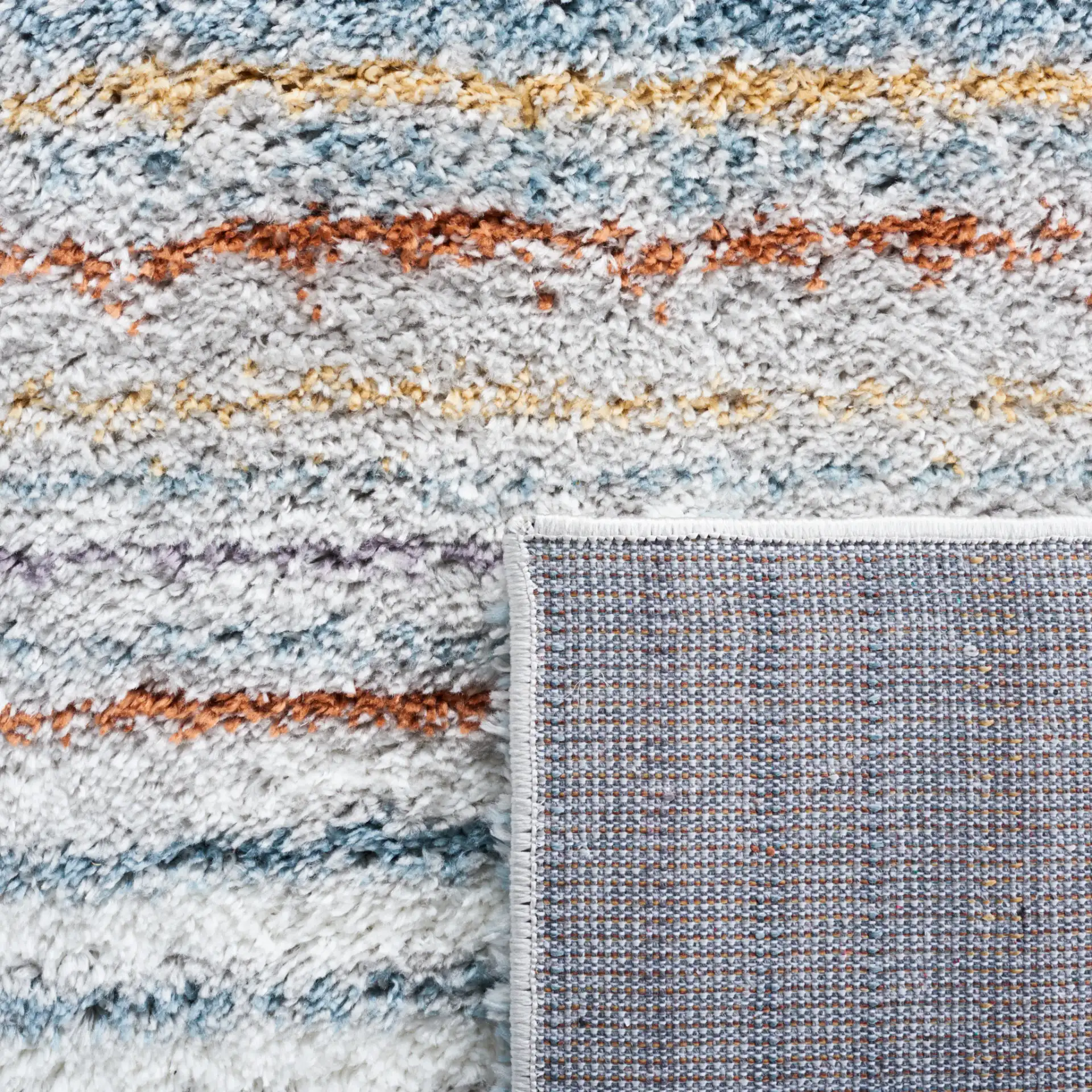 Berber Gradient Stripe Shag Rug in Blue Rust / Ivory in a styled room