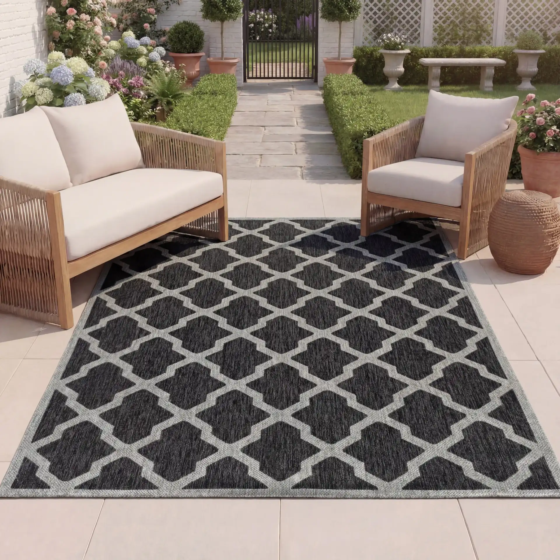 Beach House Moroccan Lattice Outdoor Rug in Charcoal / Gray in a styled room