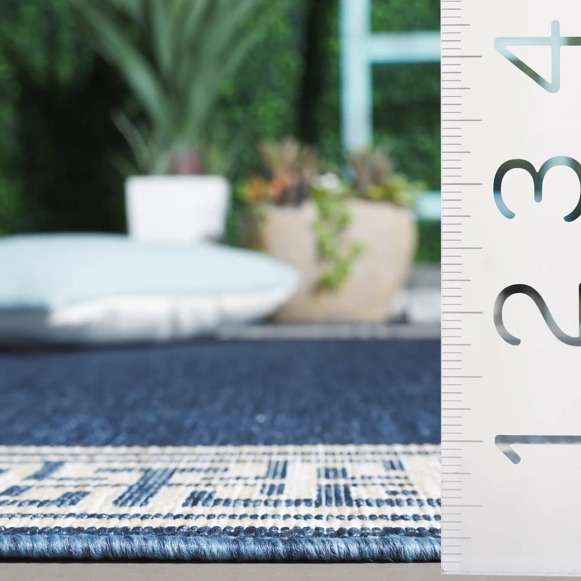 Beach House Greek Key Border Outdoor Rug in Blue / Ivory in a styled room