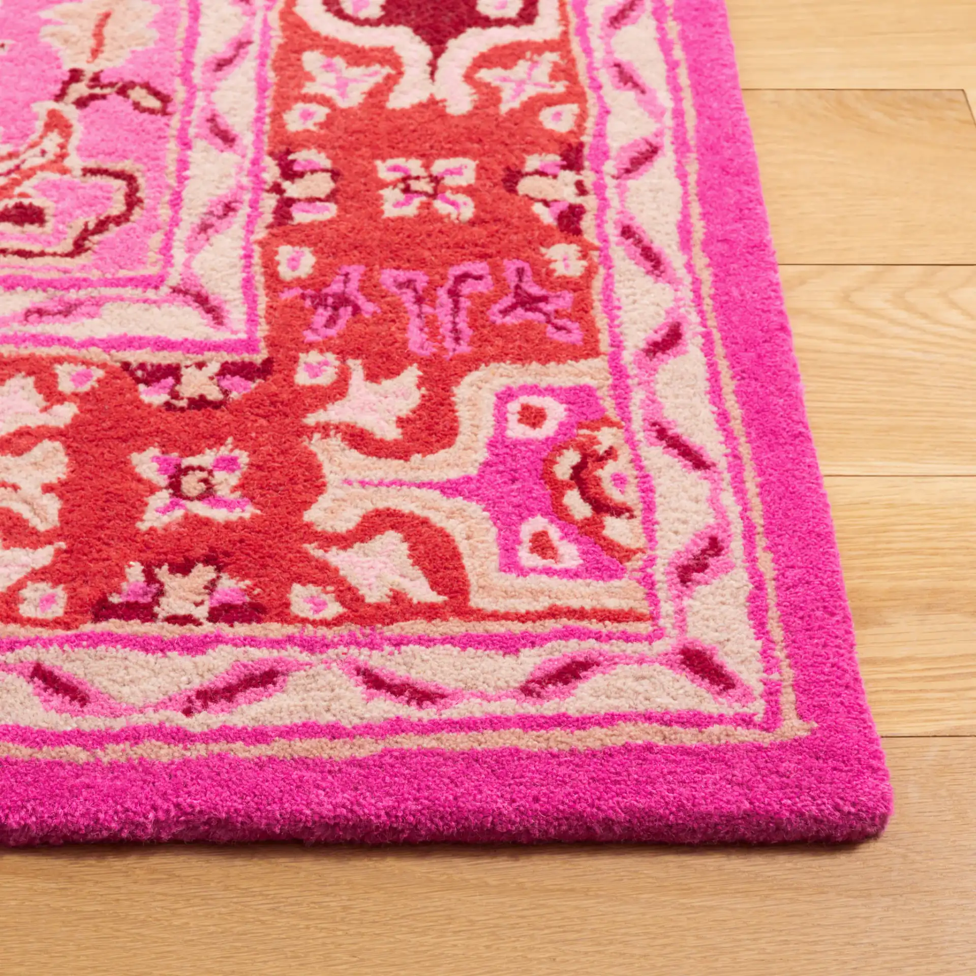 Bellagio Stepped Medallion Hand-Tufted Wool Rug in Red Pink / Ivory in a styled room