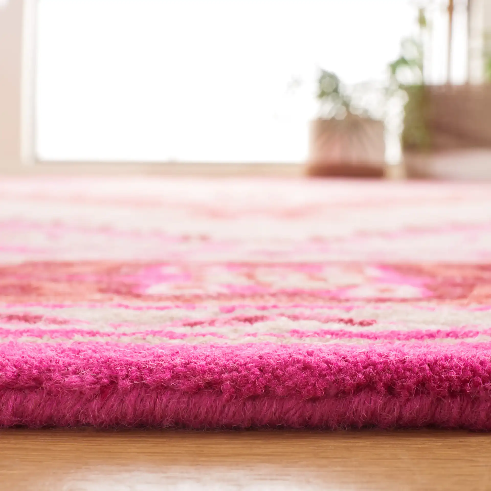 Bellagio Stepped Medallion Hand-Tufted Wool Rug in Red Pink / Ivory in a styled room