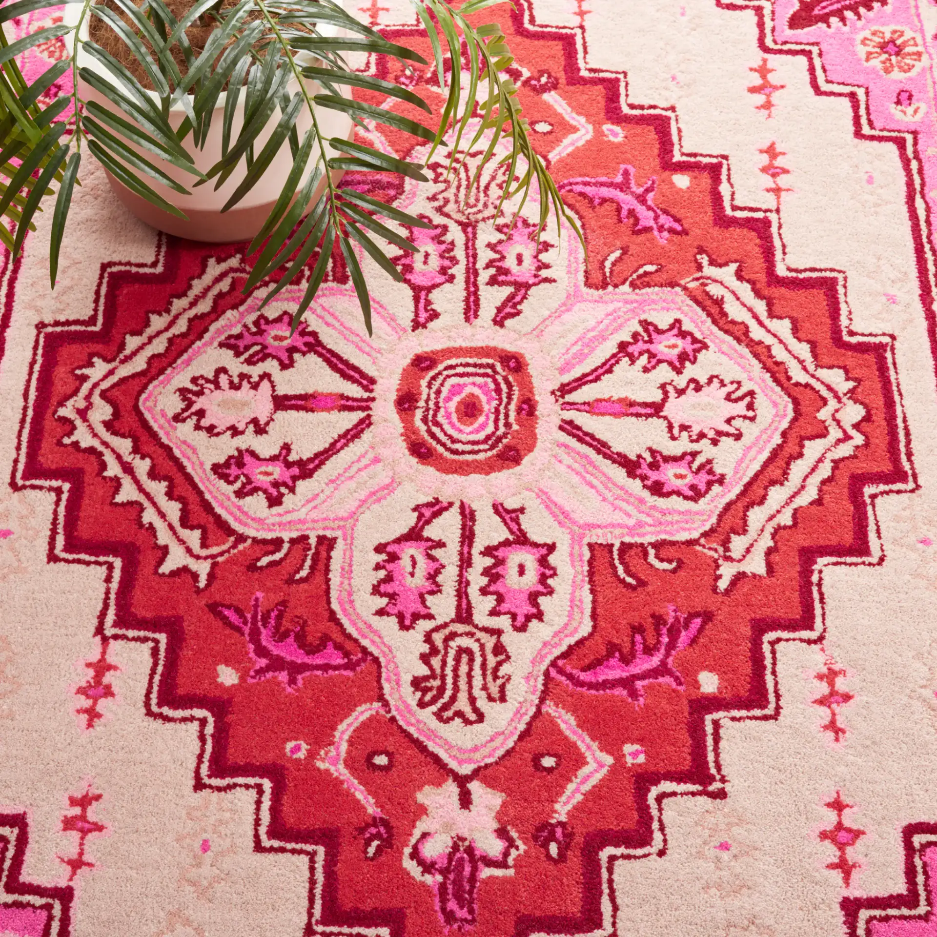 Bellagio Stepped Medallion Hand-Tufted Wool Rug in Red Pink / Ivory in a styled room