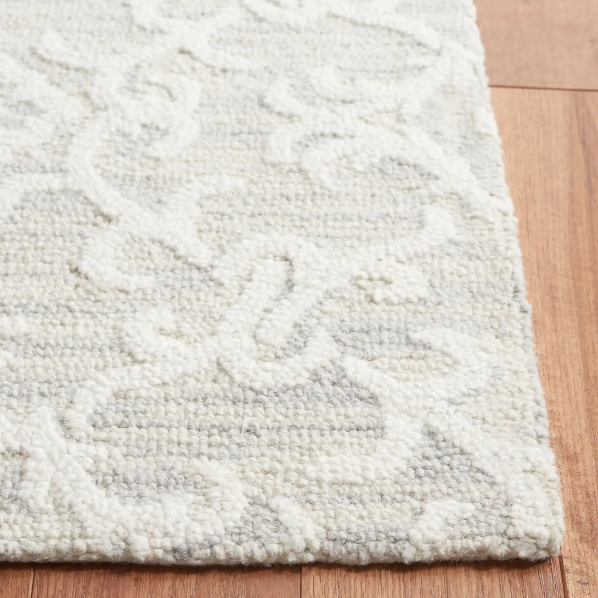 Blossom Scrollwork Hand-Tufted Wool Rug in Gray / Ivory in a styled room