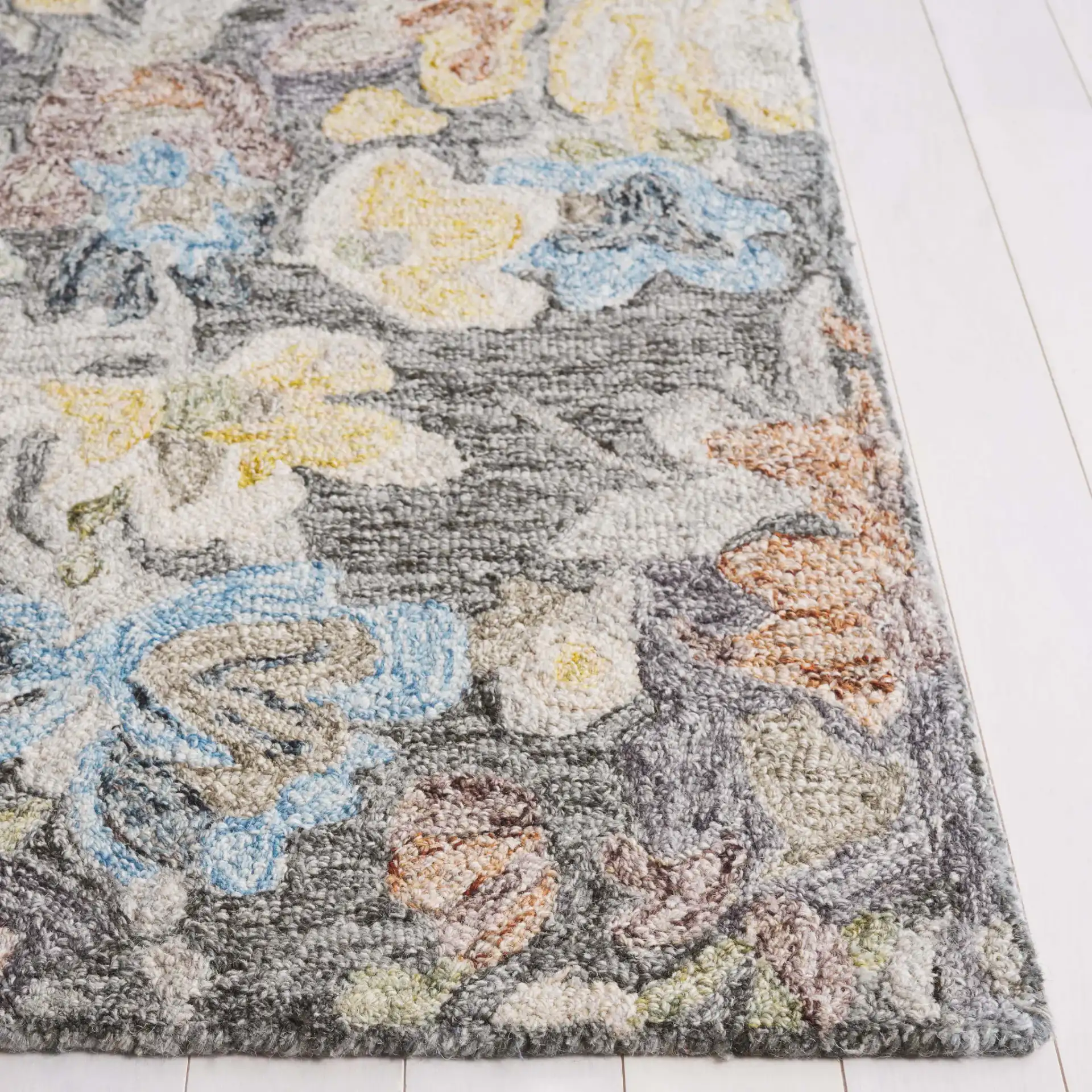 Blossom Distressed Floral Hand-Tufted Wool Rug in Green / Charcoal in a styled room