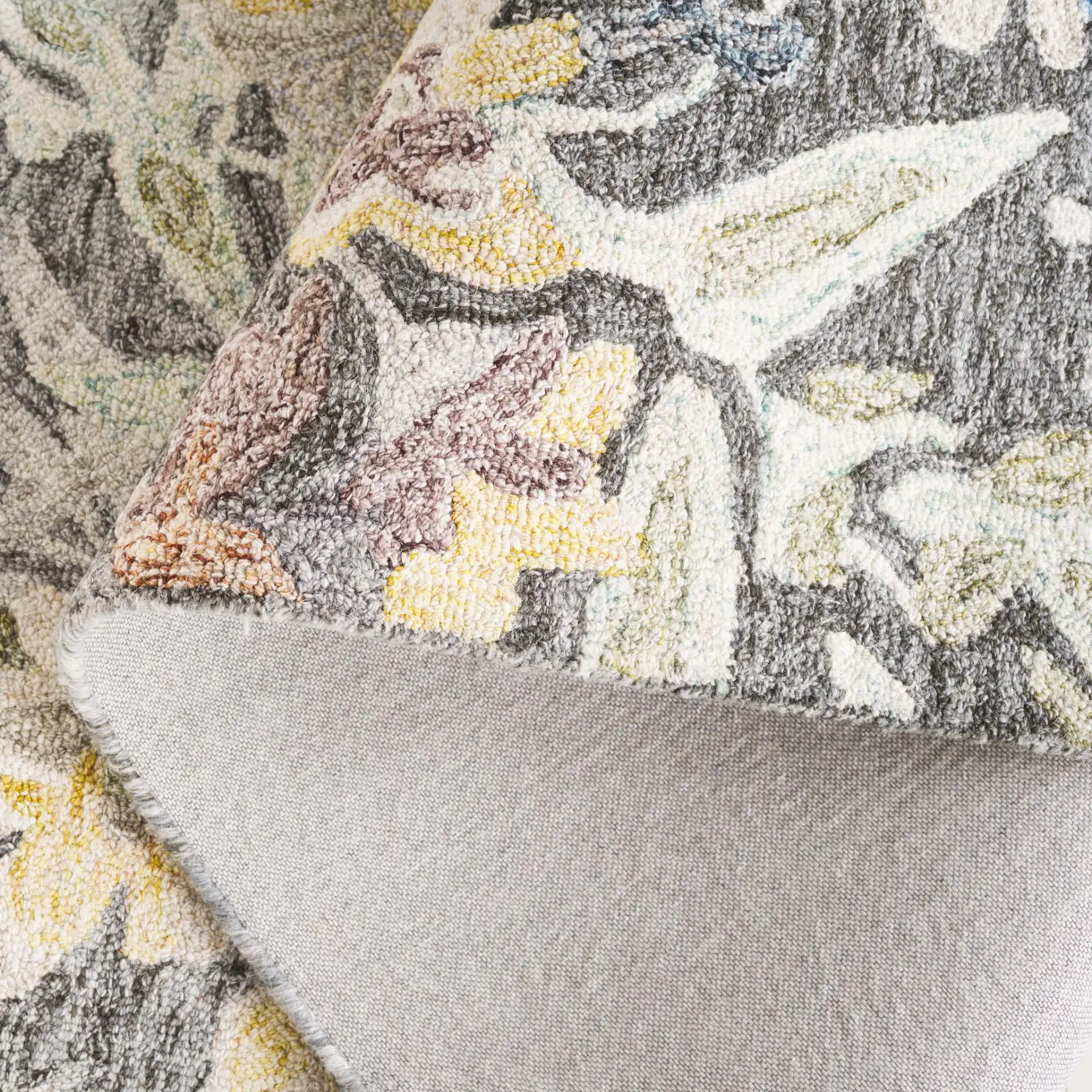 Blossom Distressed Floral Hand-Tufted Wool Rug in Green / Charcoal in a styled room