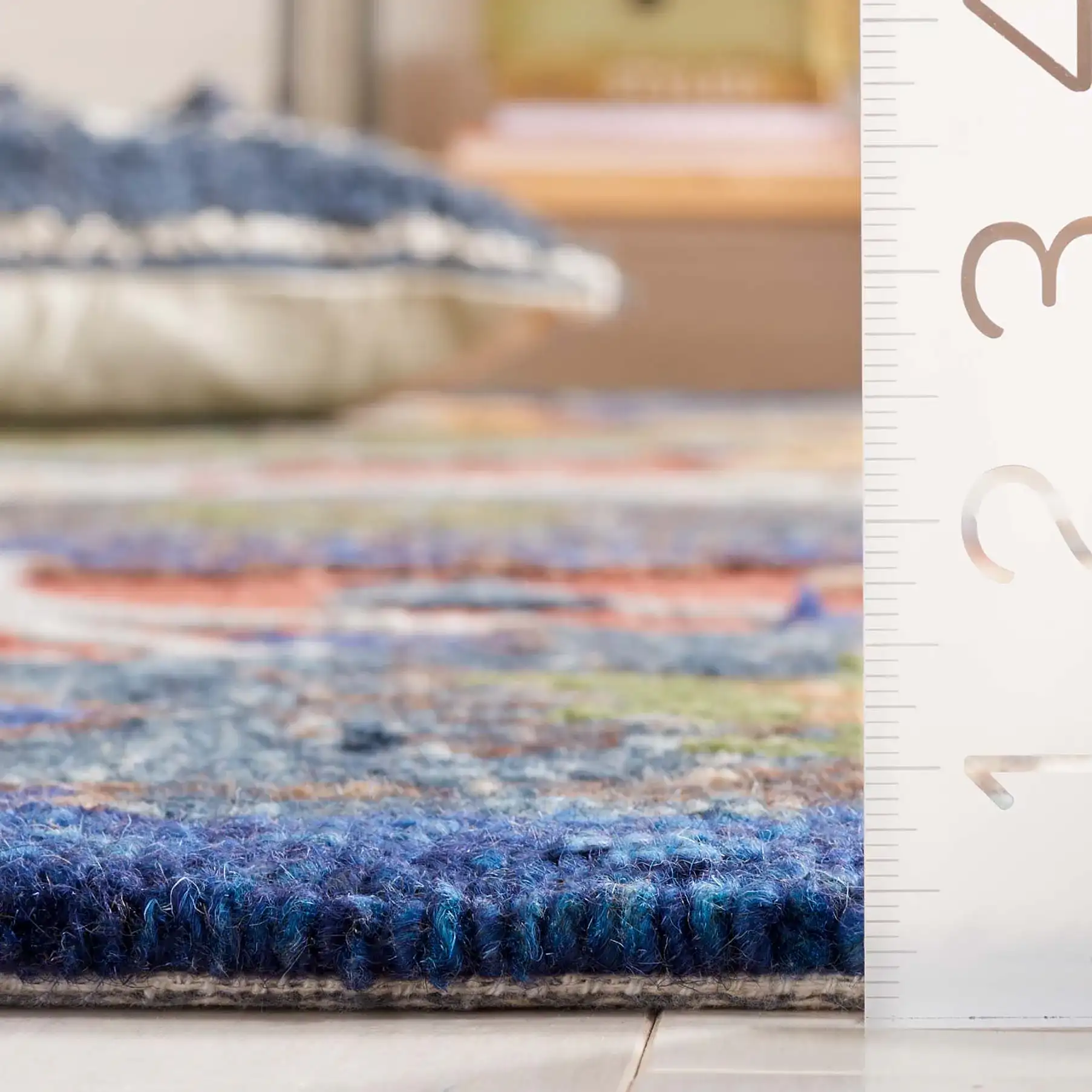 Blossom Botanical Bordered Wool Rug in Orange / Blue in a styled room
