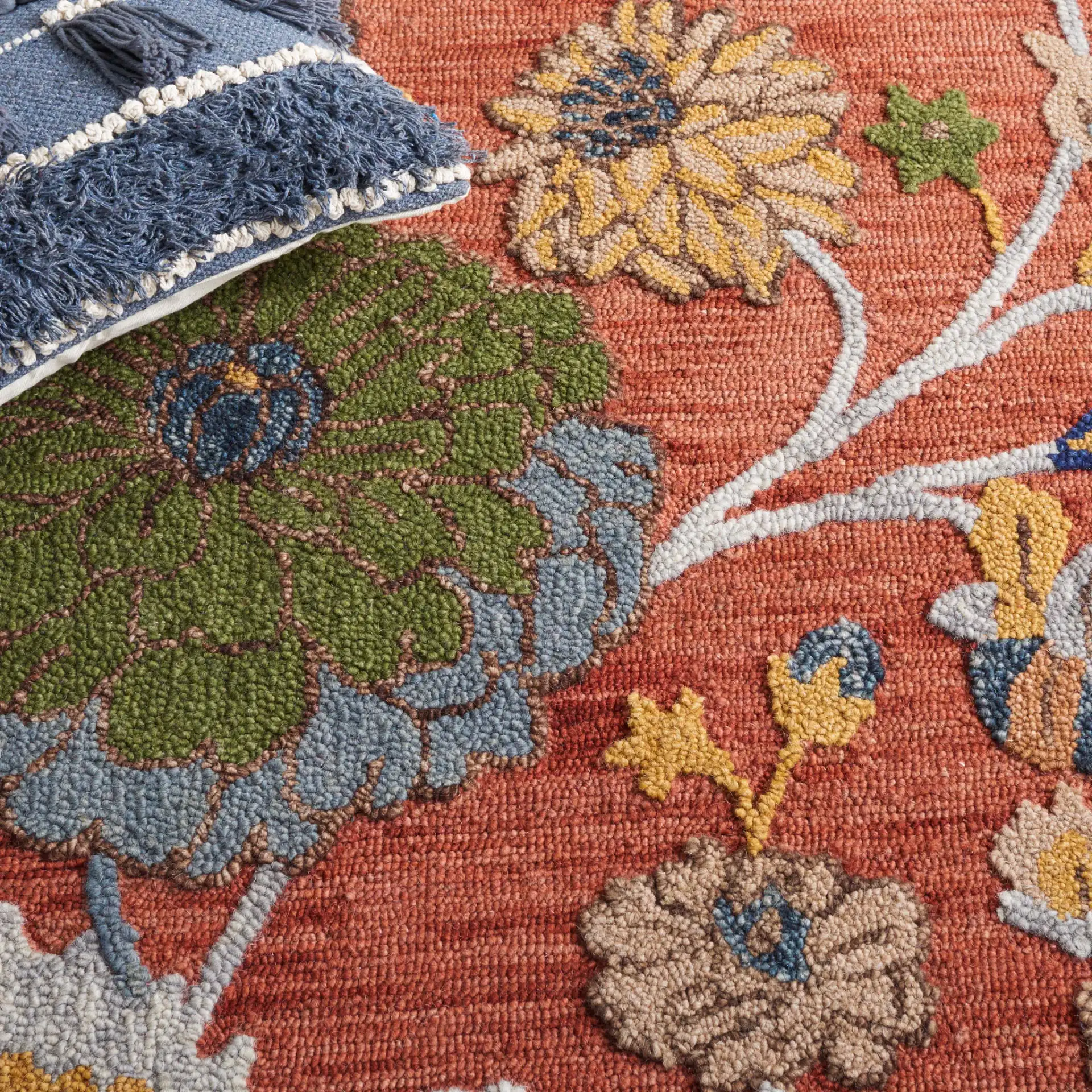 Blossom Botanical Bordered Wool Rug in Orange / Blue in a styled room