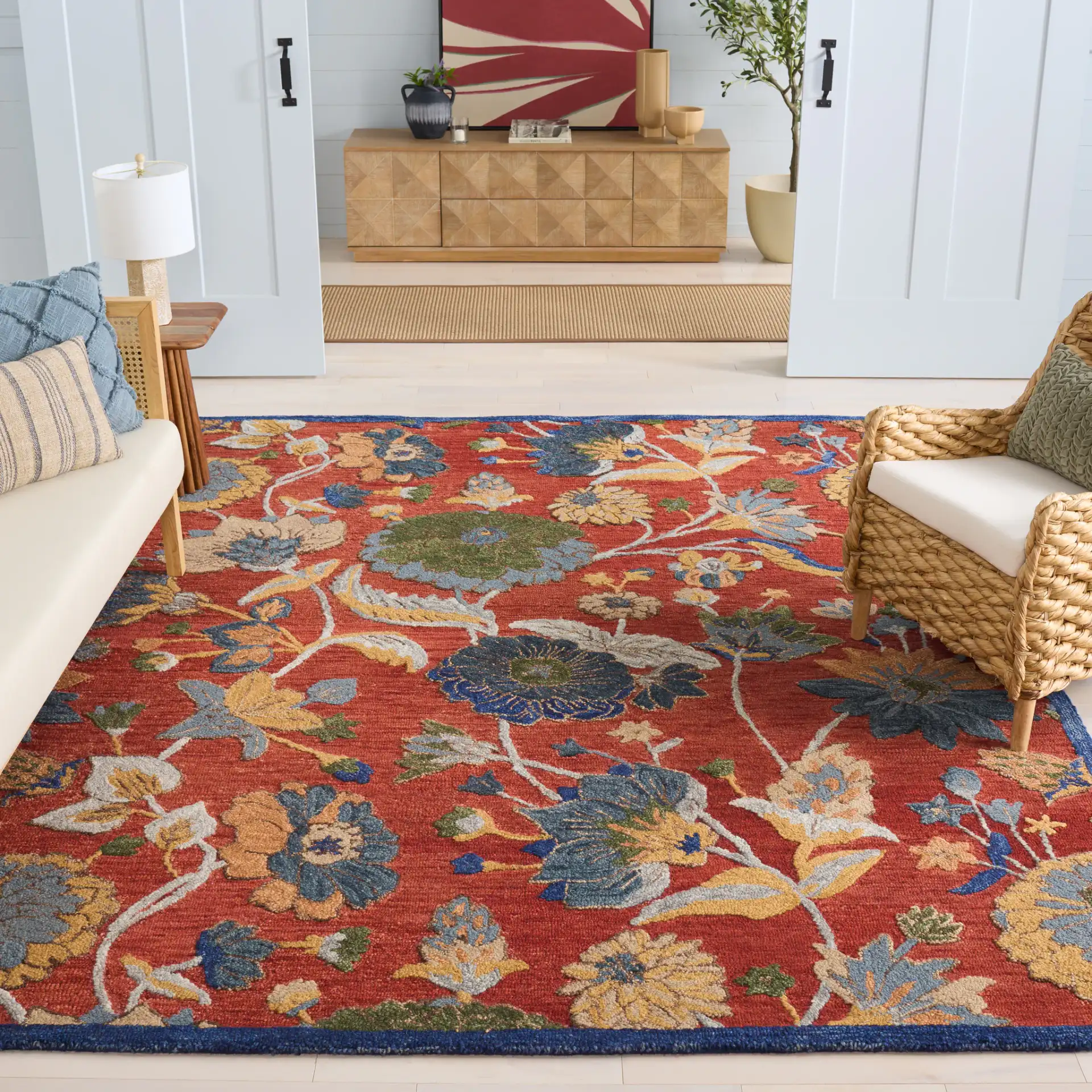 Blossom Botanical Bordered Wool Rug in Orange / Blue in a styled room