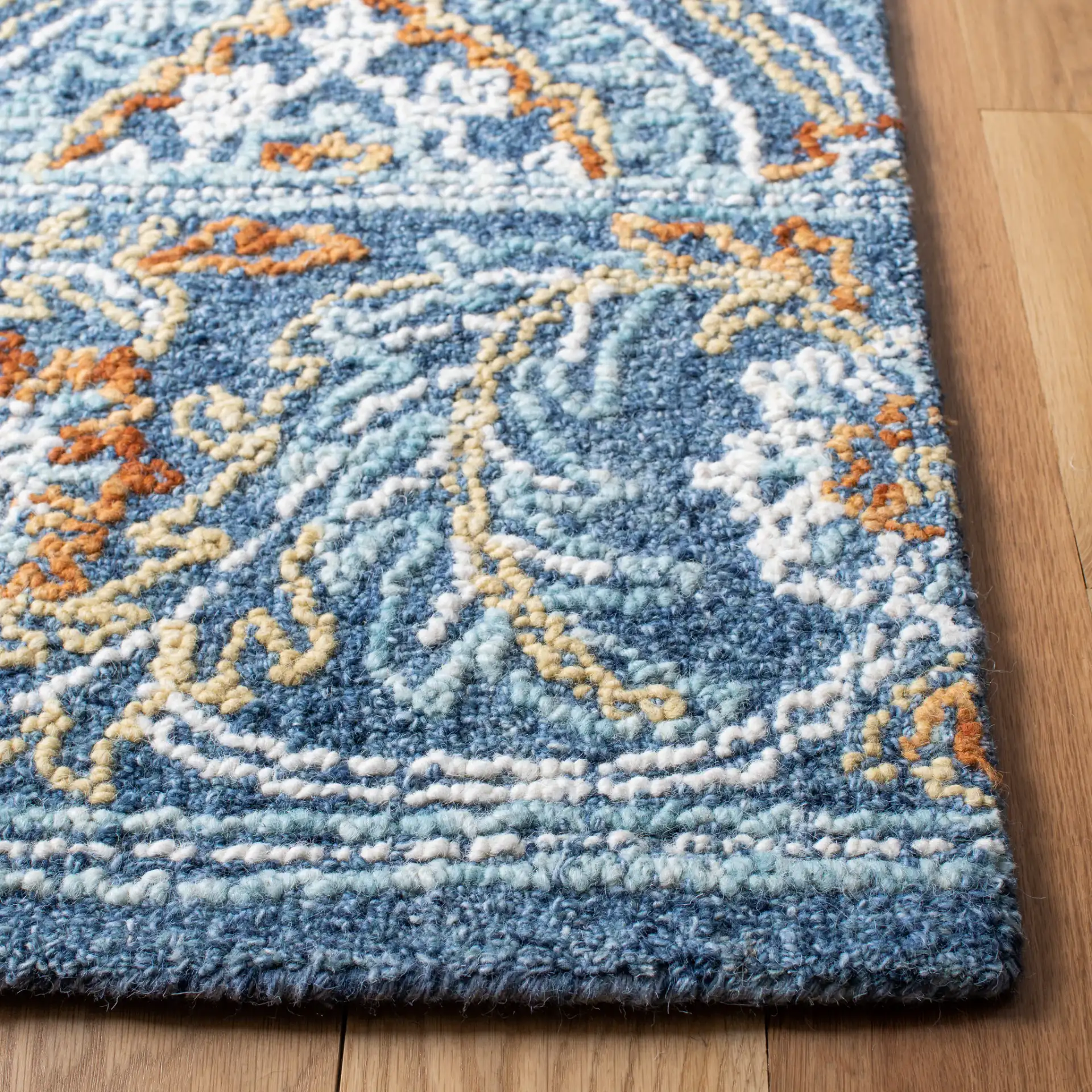Blossom Floral Ogee Hand-Tufted Wool Rug in Navy / Yellow in a styled room