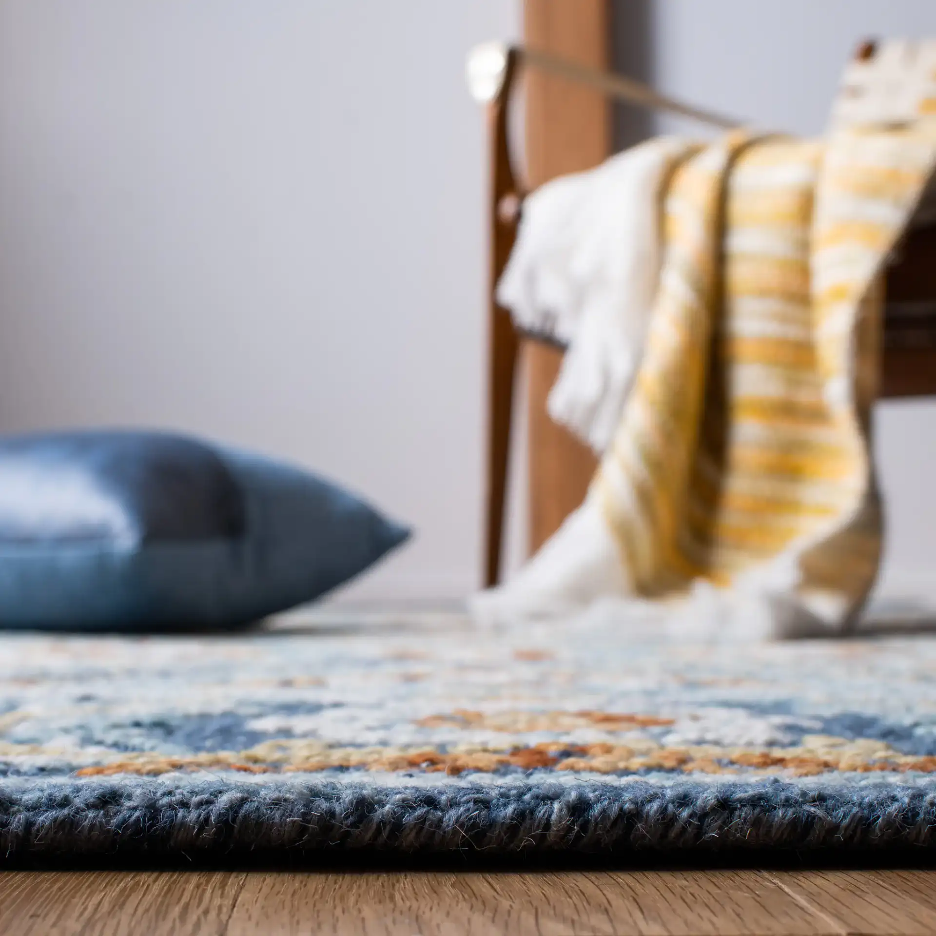Blossom Floral Ogee Hand-Tufted Wool Rug in Navy / Yellow in a styled room