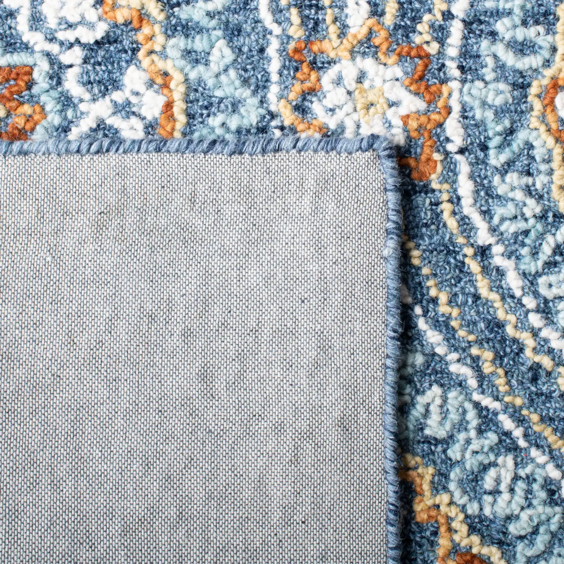 Blossom Floral Ogee Hand-Tufted Wool Rug in Navy / Yellow in a styled room