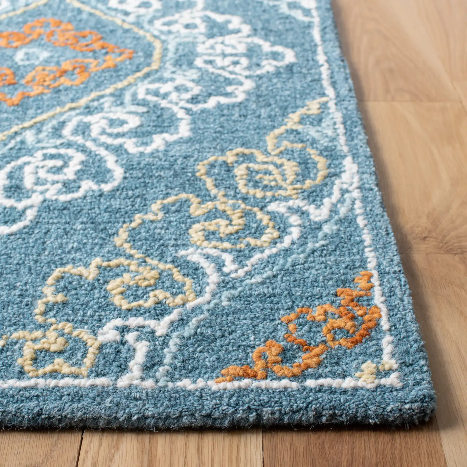 Blossom Damask Diamond Hand-Tufted Wool Rug in Blue / Yellow in a styled room