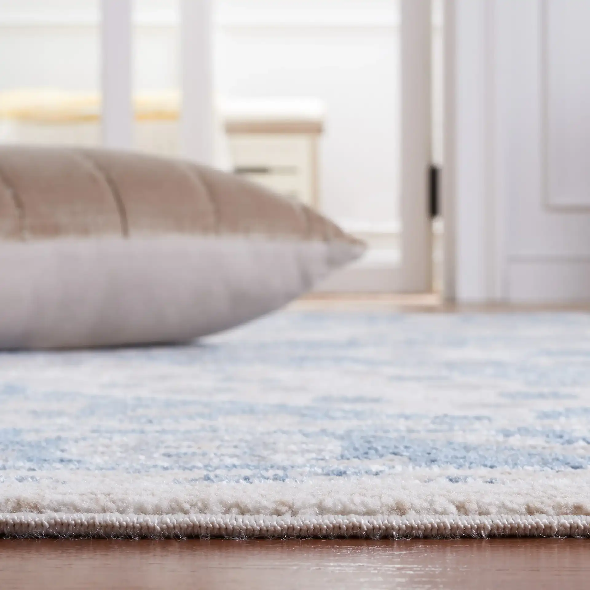 Blair Washable Medallion Bordered Rug in Beige / Gray Blue in a styled room