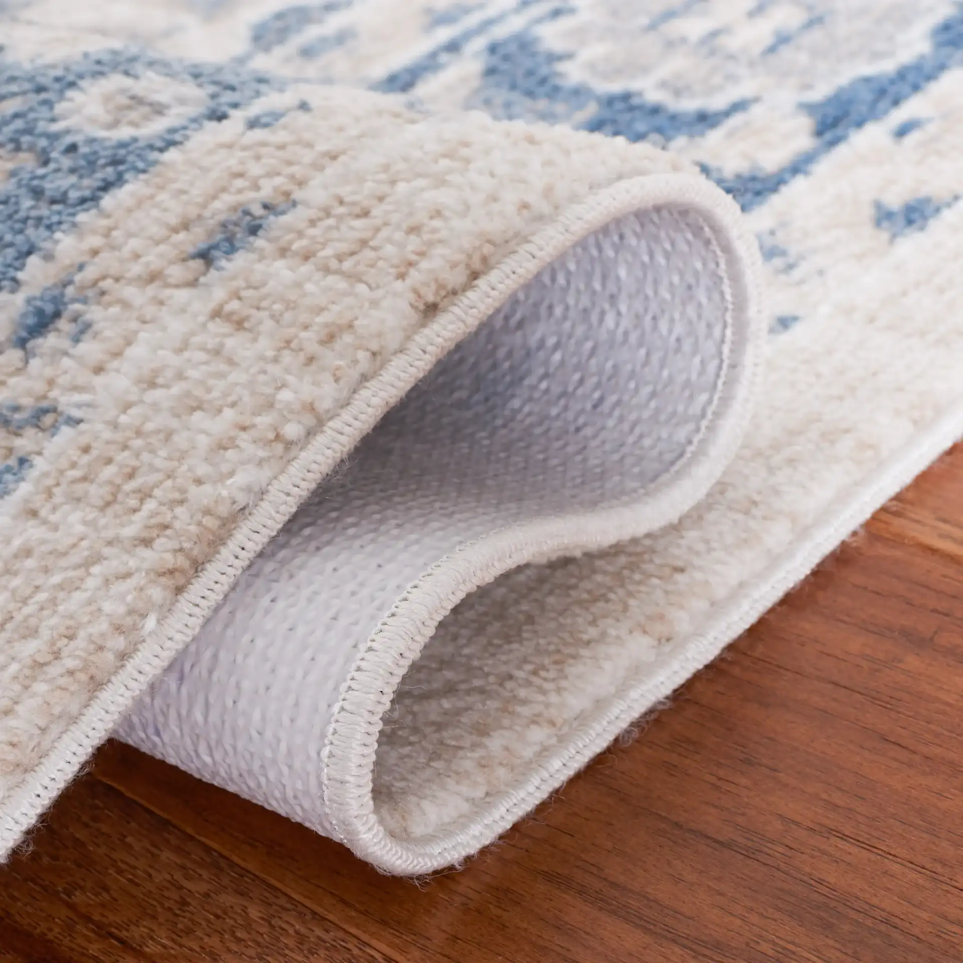 Blair Washable Medallion Bordered Rug in Beige / Gray Blue in a styled room