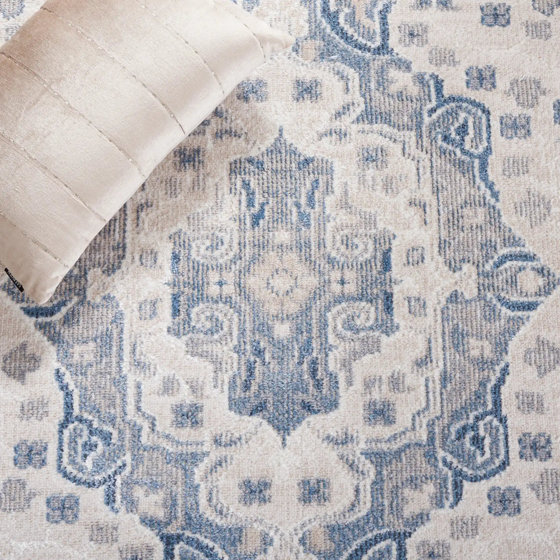 Blair Washable Medallion Bordered Rug in Beige / Gray Blue in a styled room