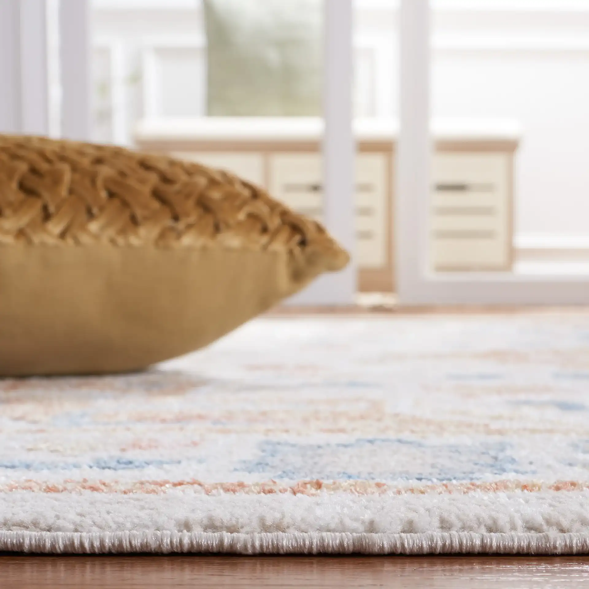 Blair Washable Diamond Medallion Rug in Beige / Rust in a styled room