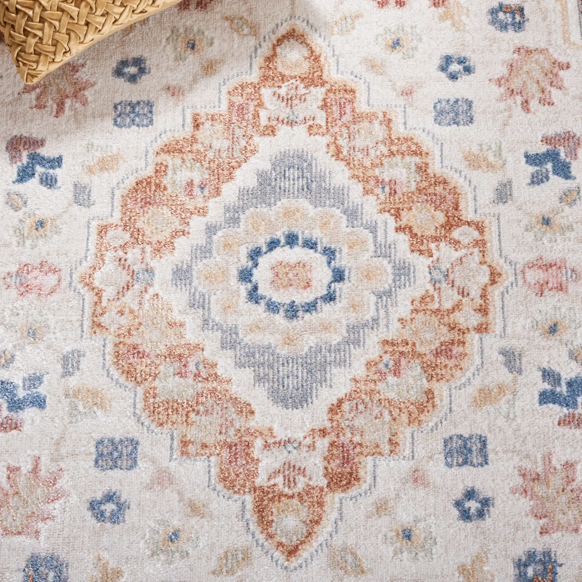Blair Washable Diamond Medallion Rug in Beige / Rust in a styled room