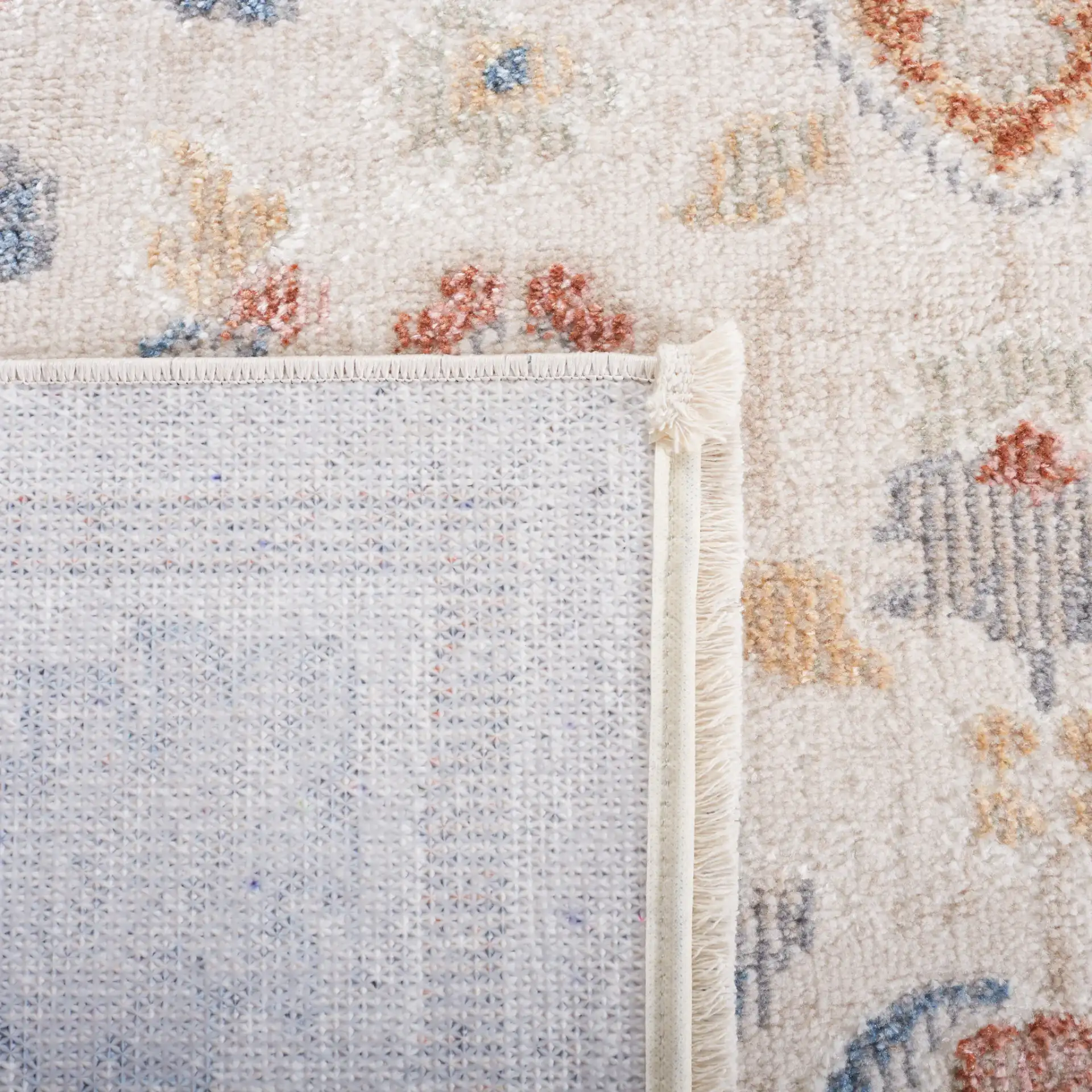 Blair Washable Diamond Medallion Rug in Beige / Rust in a styled room