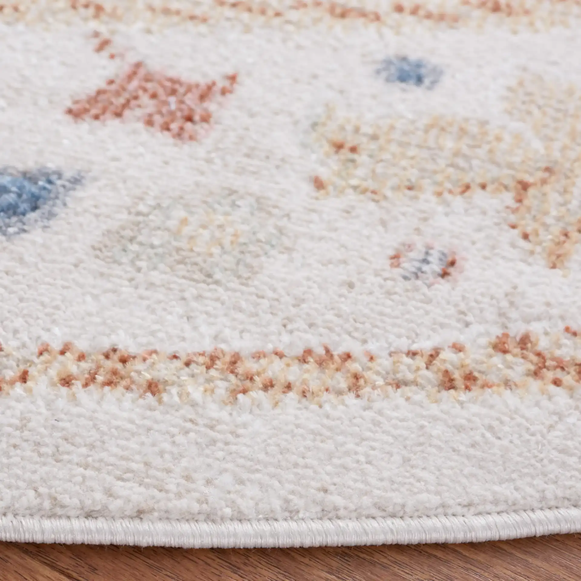 Blair Washable Diamond Medallion Rug in Beige / Rust in a styled room