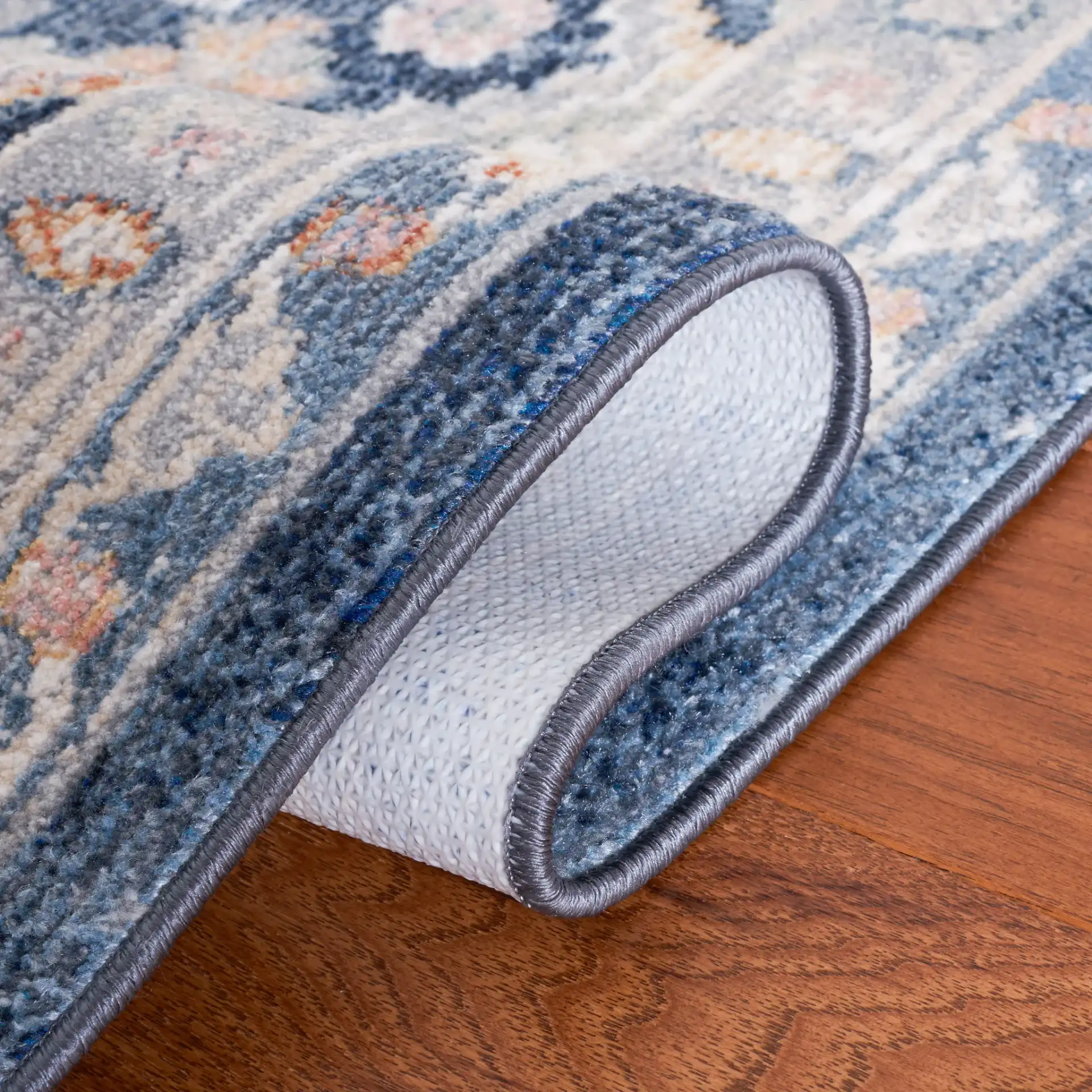 Blair Geometric Diamond Medallion Washable Rug in Gray / Navy in a styled room