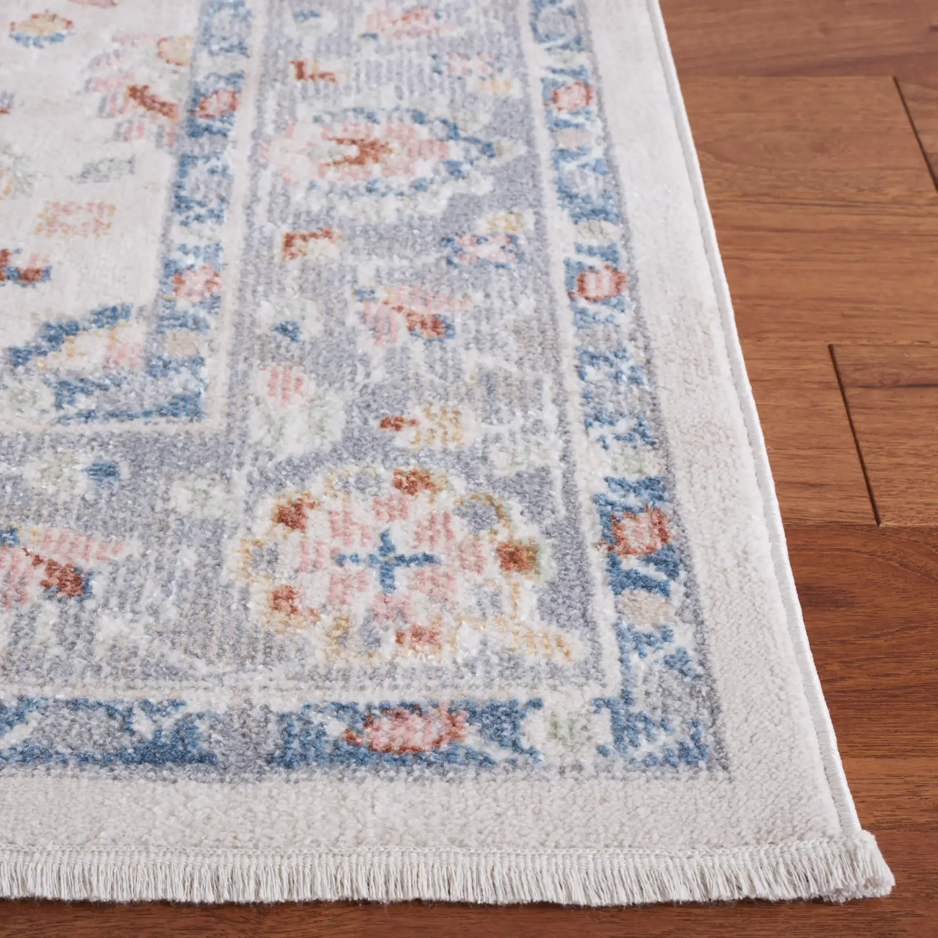 Blair Floral Bordered Washable Rug in Beige / Gray in a styled room