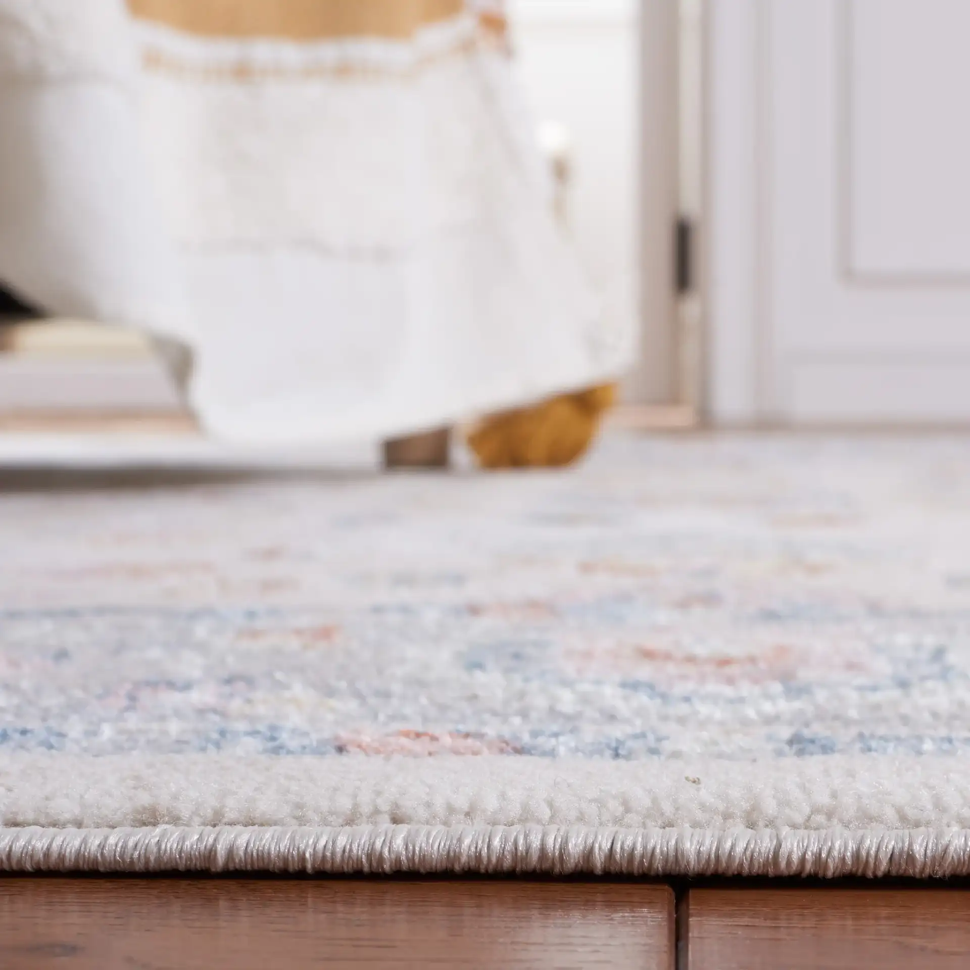 Blair Floral Bordered Washable Rug in Beige / Gray in a styled room