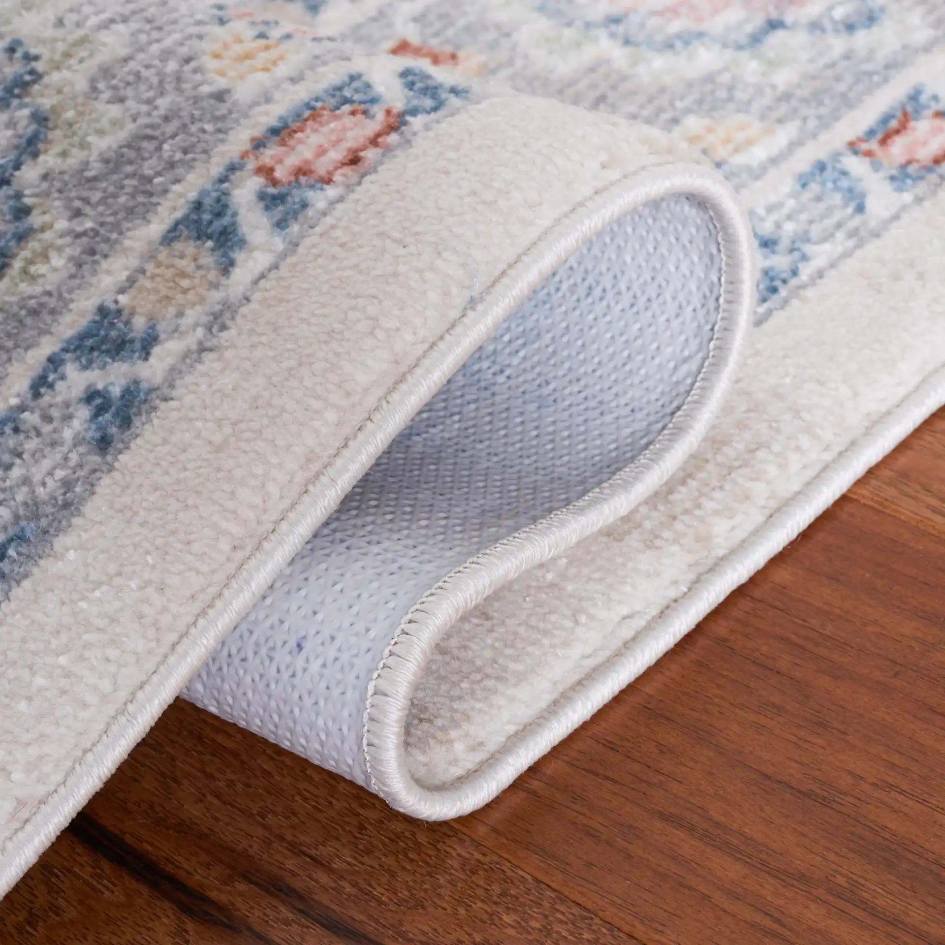 Blair Floral Bordered Washable Rug in Beige / Gray in a styled room