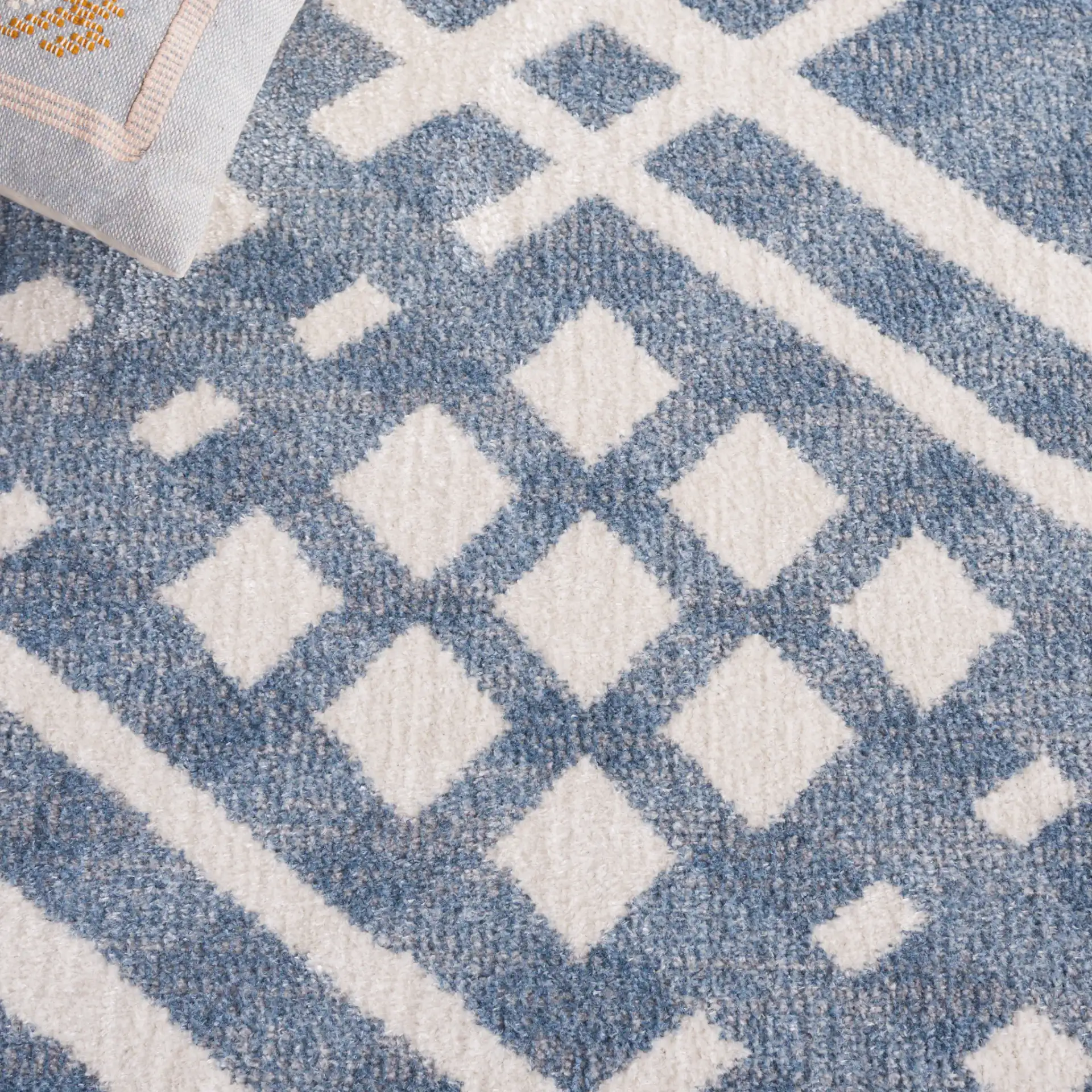 Blair Diamond Lattice Washable Rug in Blue / Ivory in a styled room
