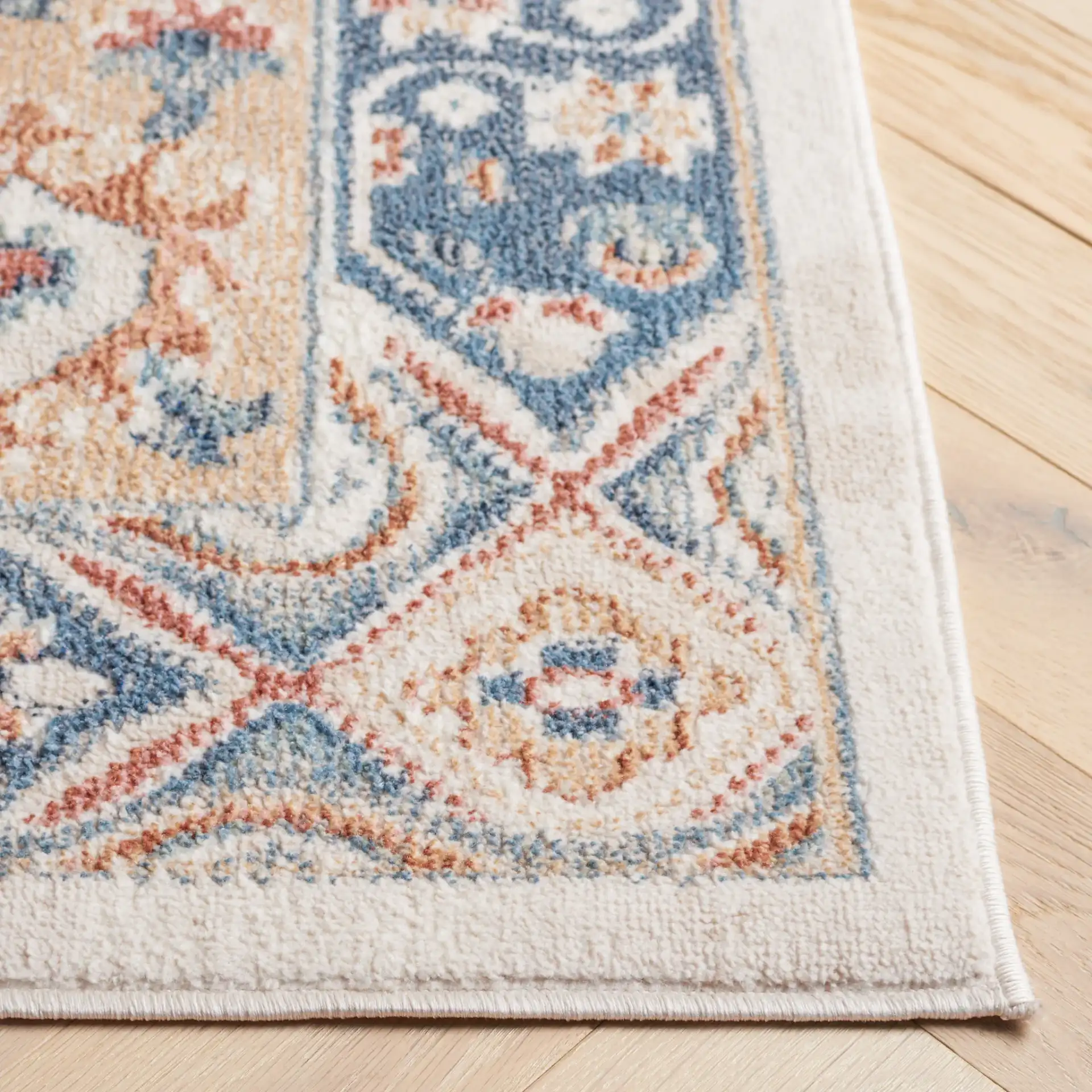 Blair Tribal Medallion Washable Rug in Ivory / Blue in a styled room