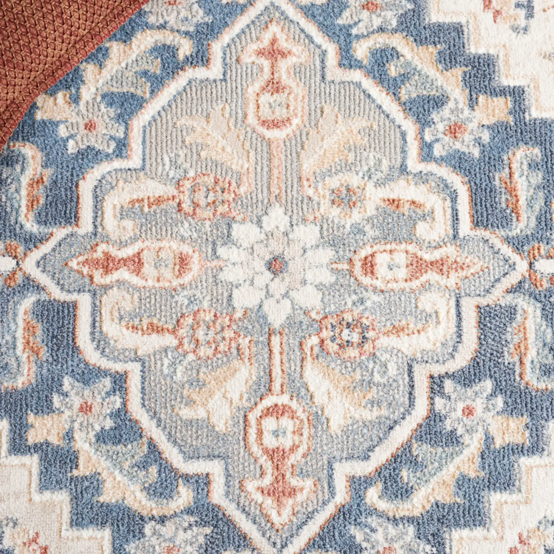 Blair Tribal Medallion Washable Rug in Ivory / Blue in a styled room