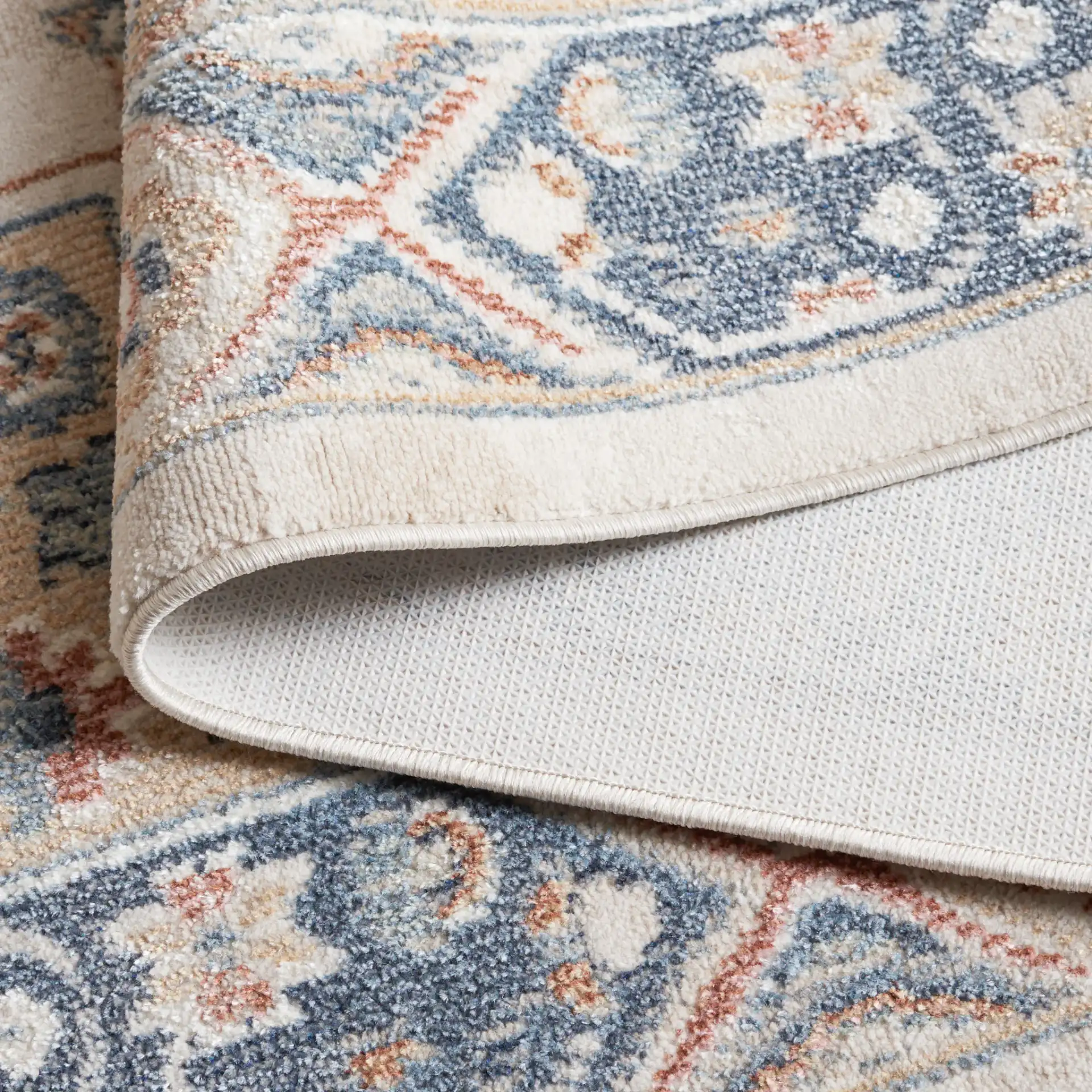 Blair Tribal Medallion Washable Rug in Ivory / Blue in a styled room