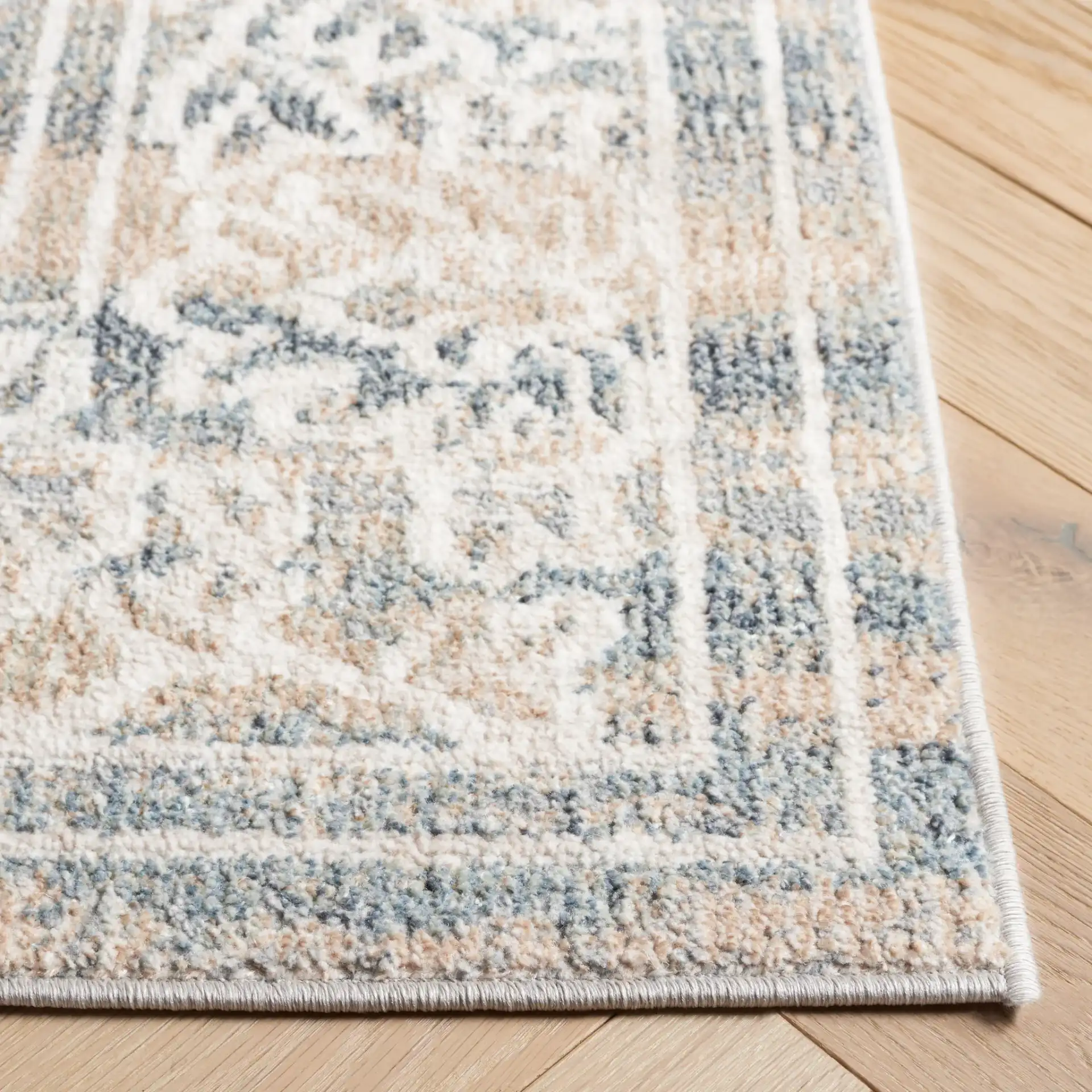 Blair Bordered Floral Washable Rug in Ivory / Blue in a styled room