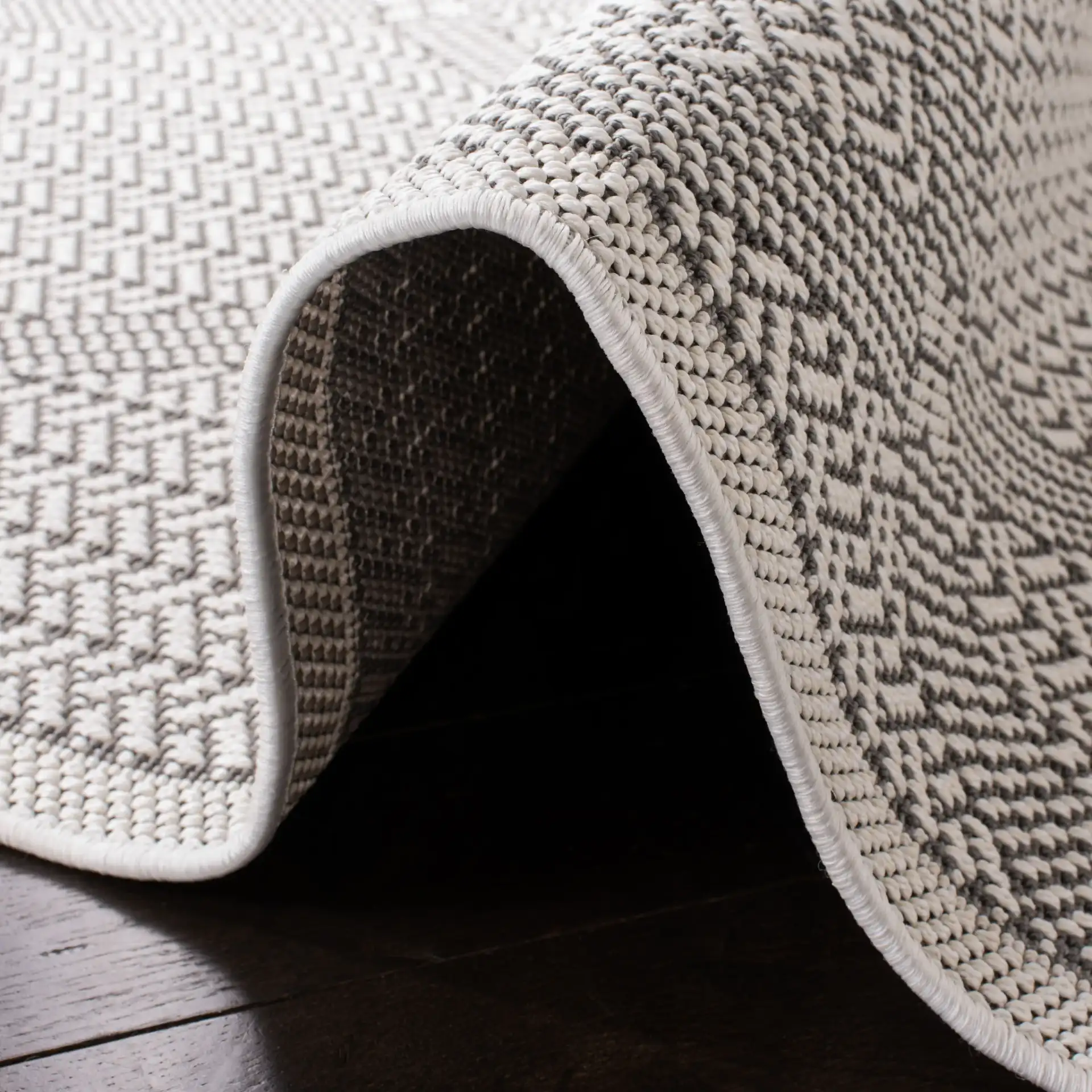 Bermuda Diamond Lattice Washable Outdoor Rug in Cream / Gray in a styled room
