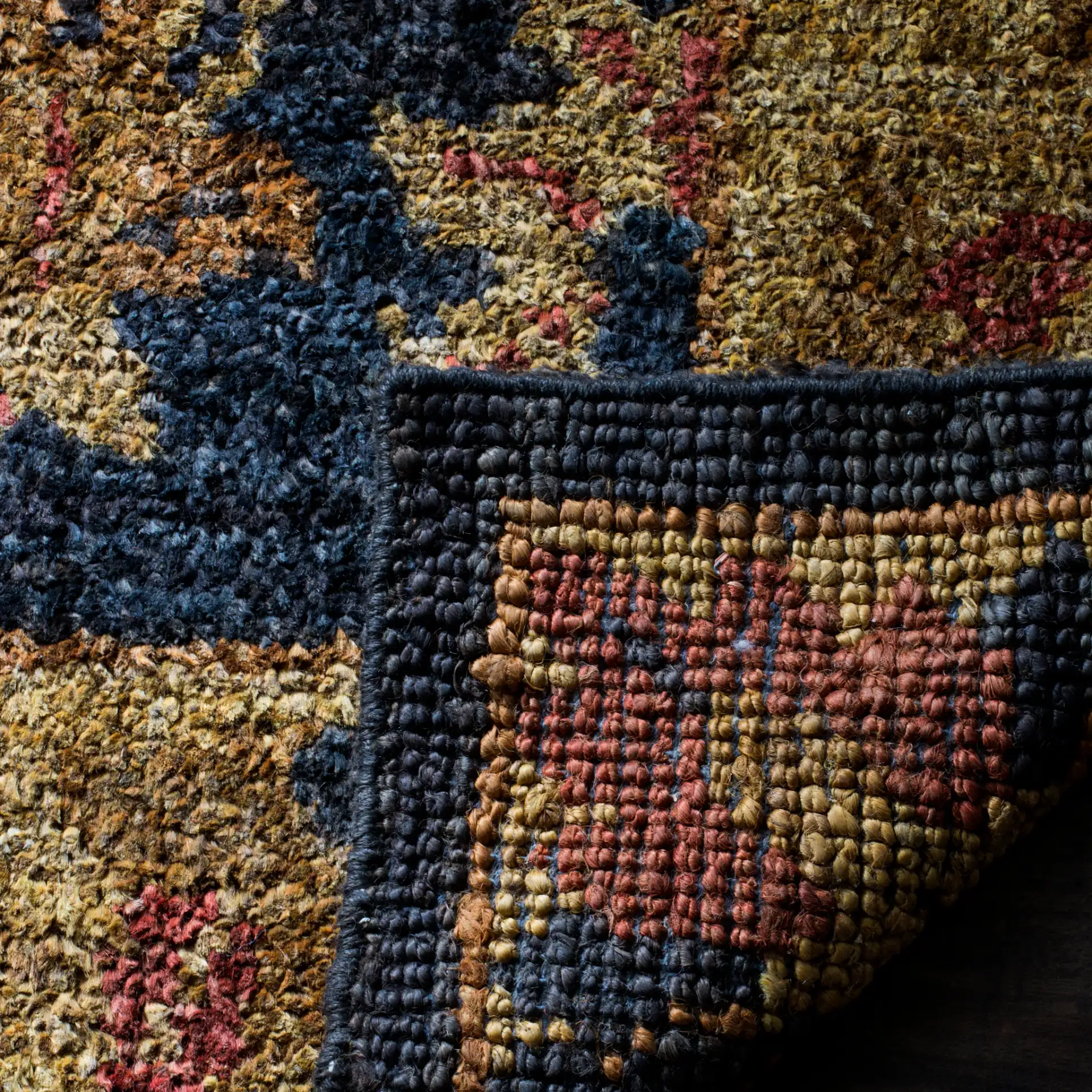 Bohemian Vine And Blossom Hand-Tufted Rug in Charcoal / Gold in a styled room