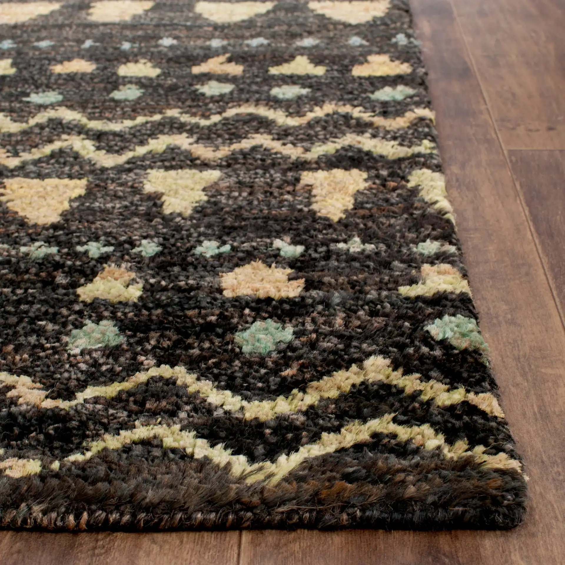 Bohemian Banded Chevron Hand-Knotted Jute Rug in Black / Gold in a styled room