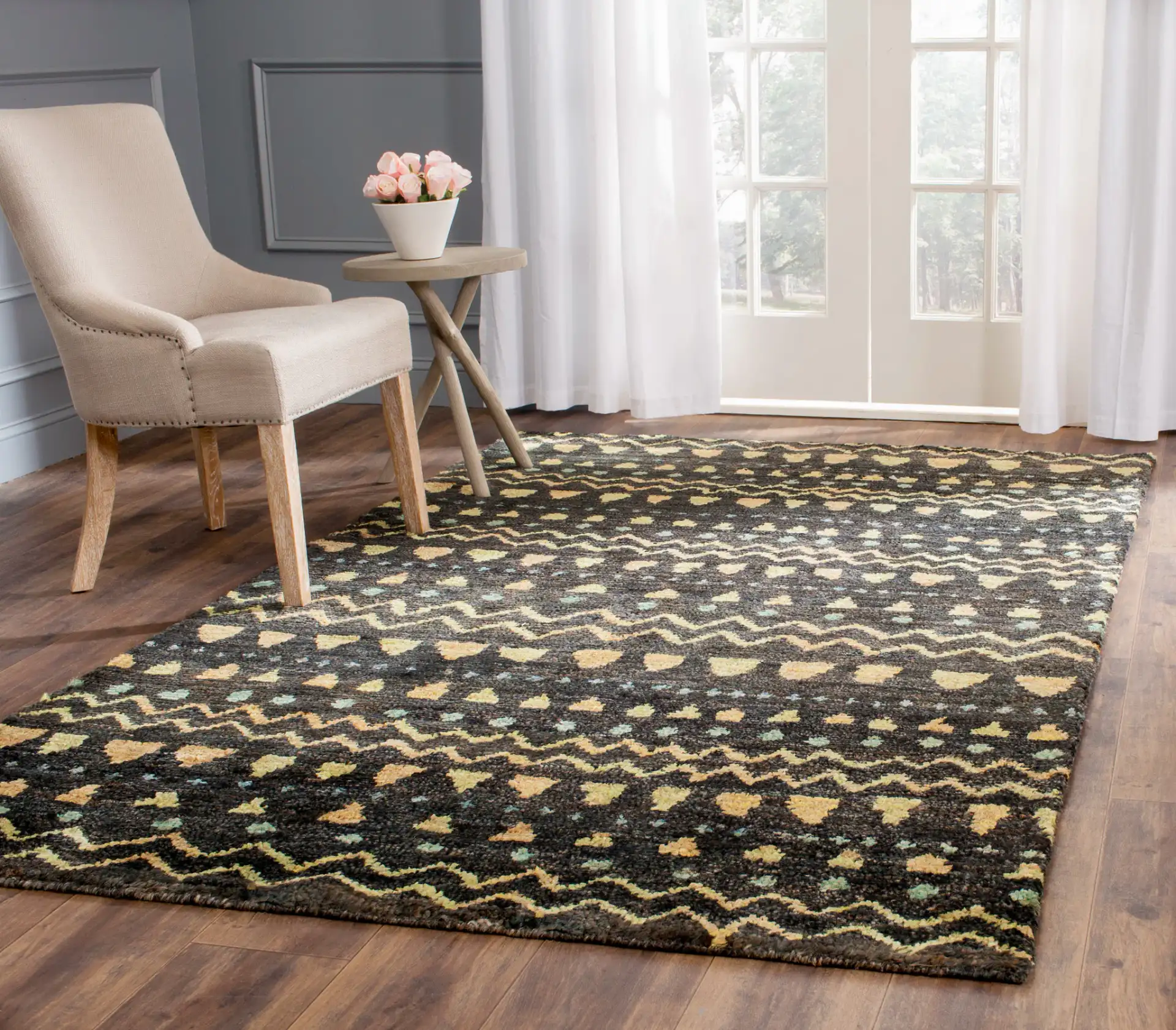 Bohemian Banded Chevron Hand-Knotted Jute Rug in Black / Gold in a styled room