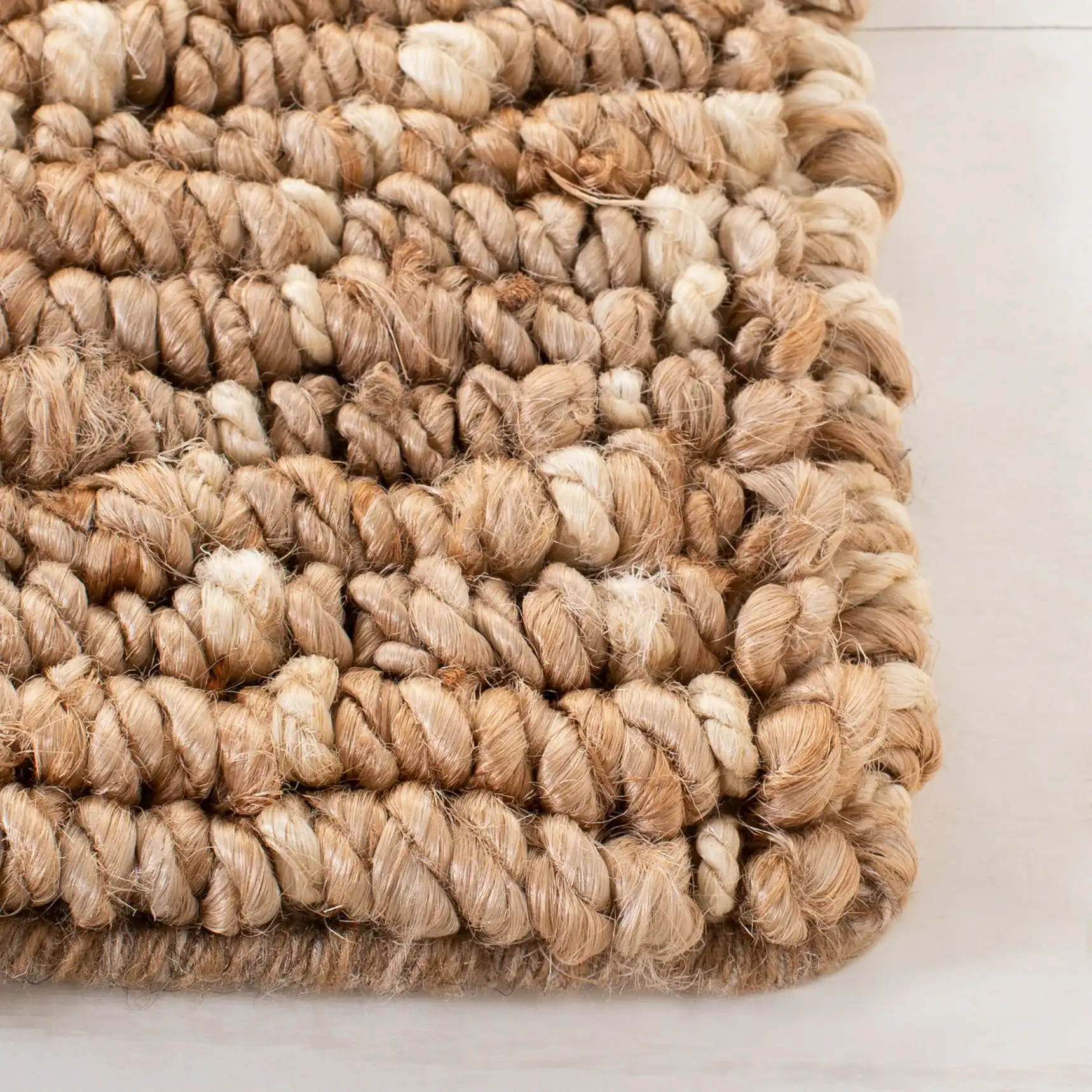 Bohemian Diamond Hand-Woven Jute Rug in Natural / Ivory in a styled room