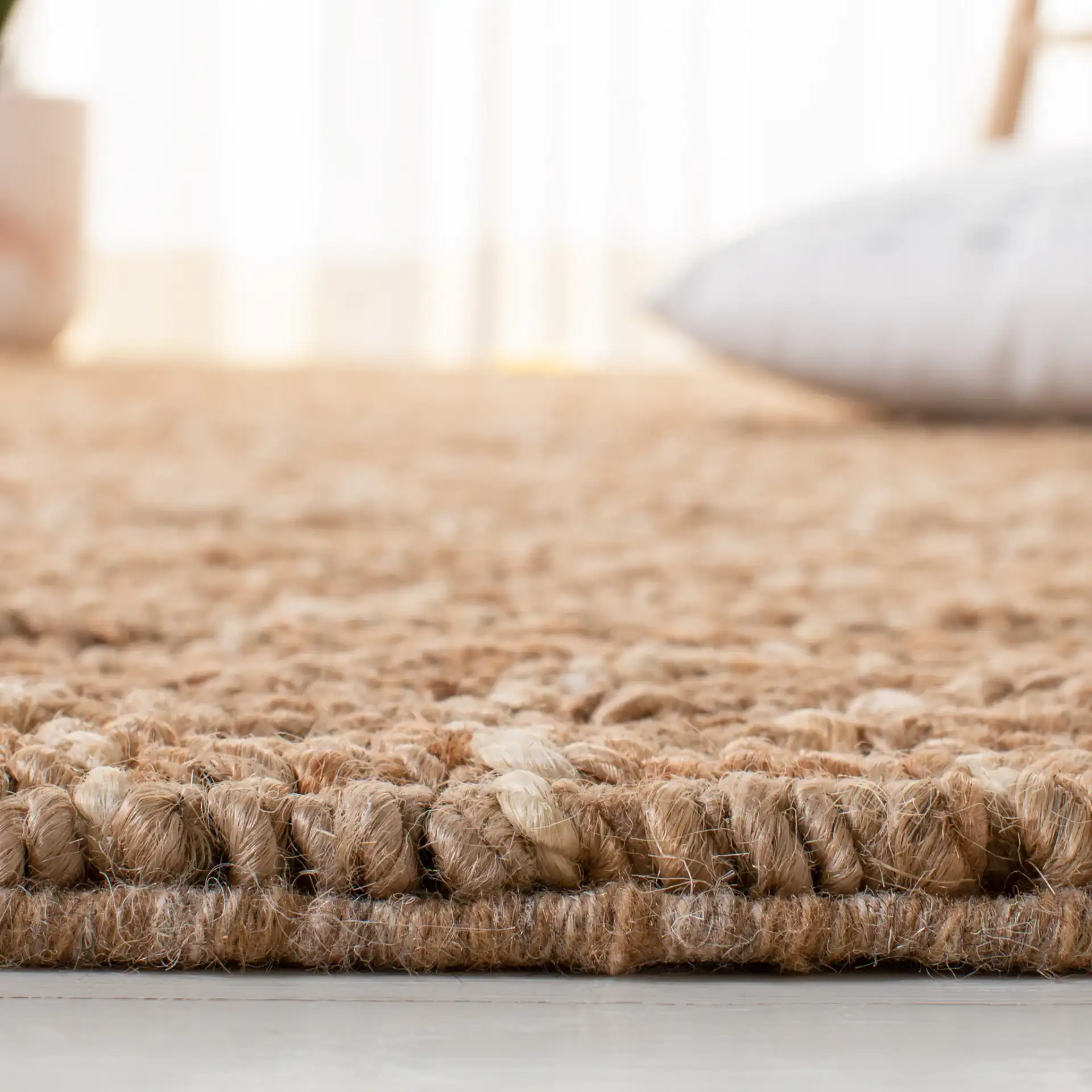 Bohemian Diamond Hand-Woven Jute Rug in Natural / Ivory in a styled room