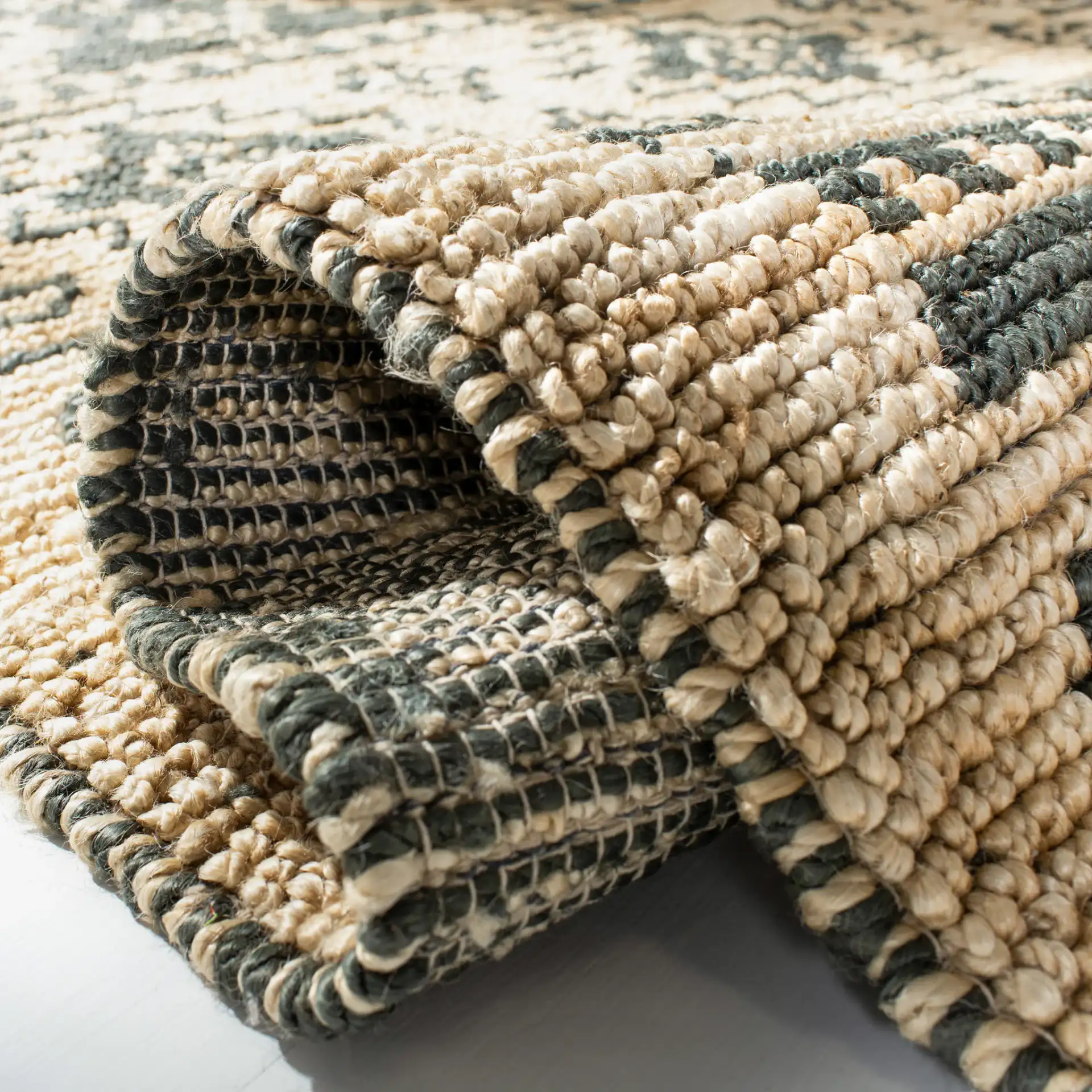 Bohemian Stepped Diamond Hand-Woven Jute Rug in Gray / Beige in a styled room
