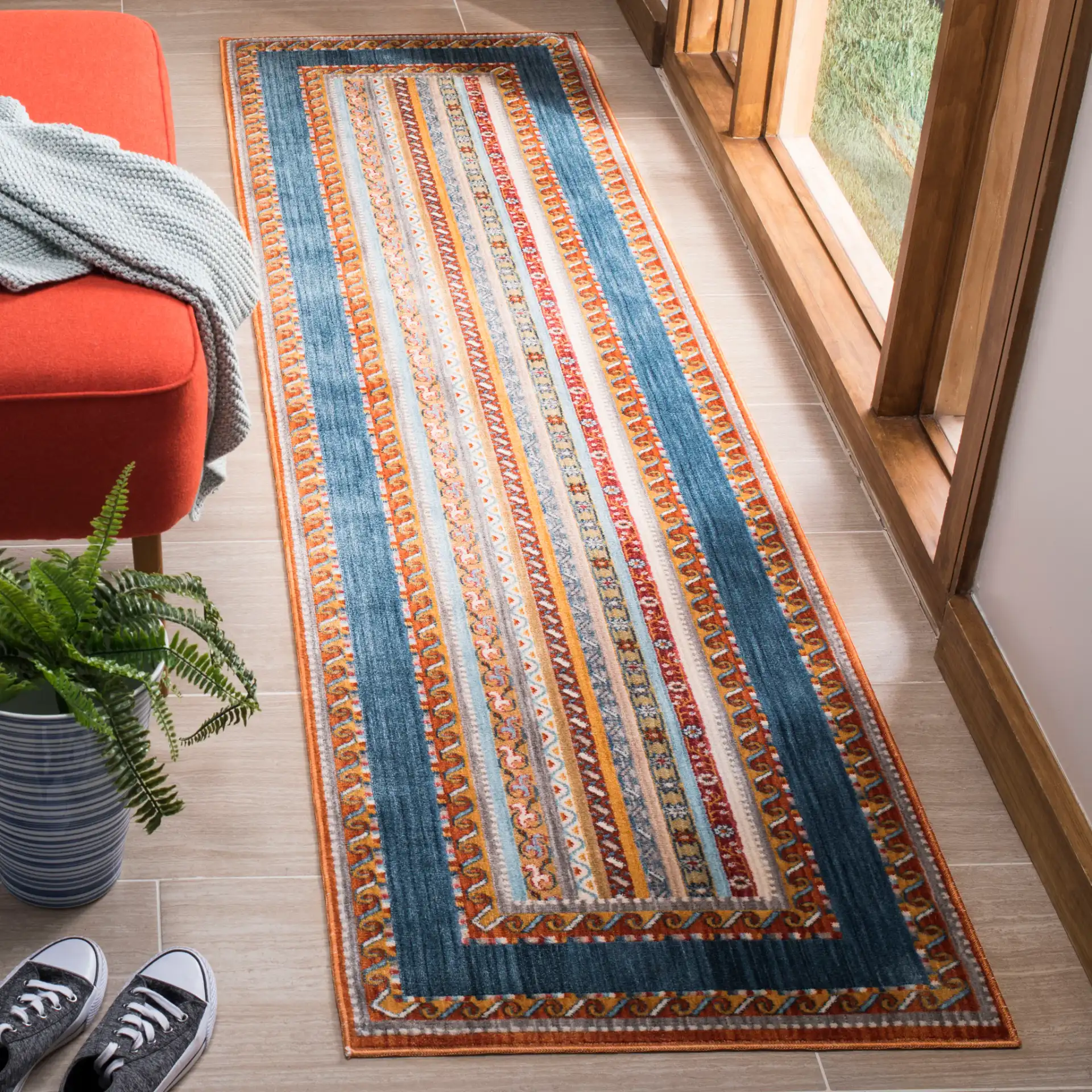 Bokhara Striped Border Rug in Blue / Orange in a styled room