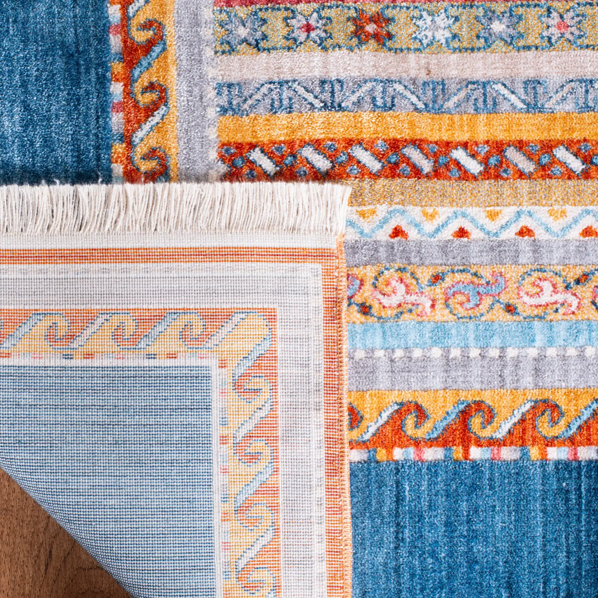 Bokhara Striped Border Rug in Blue / Orange in a styled room