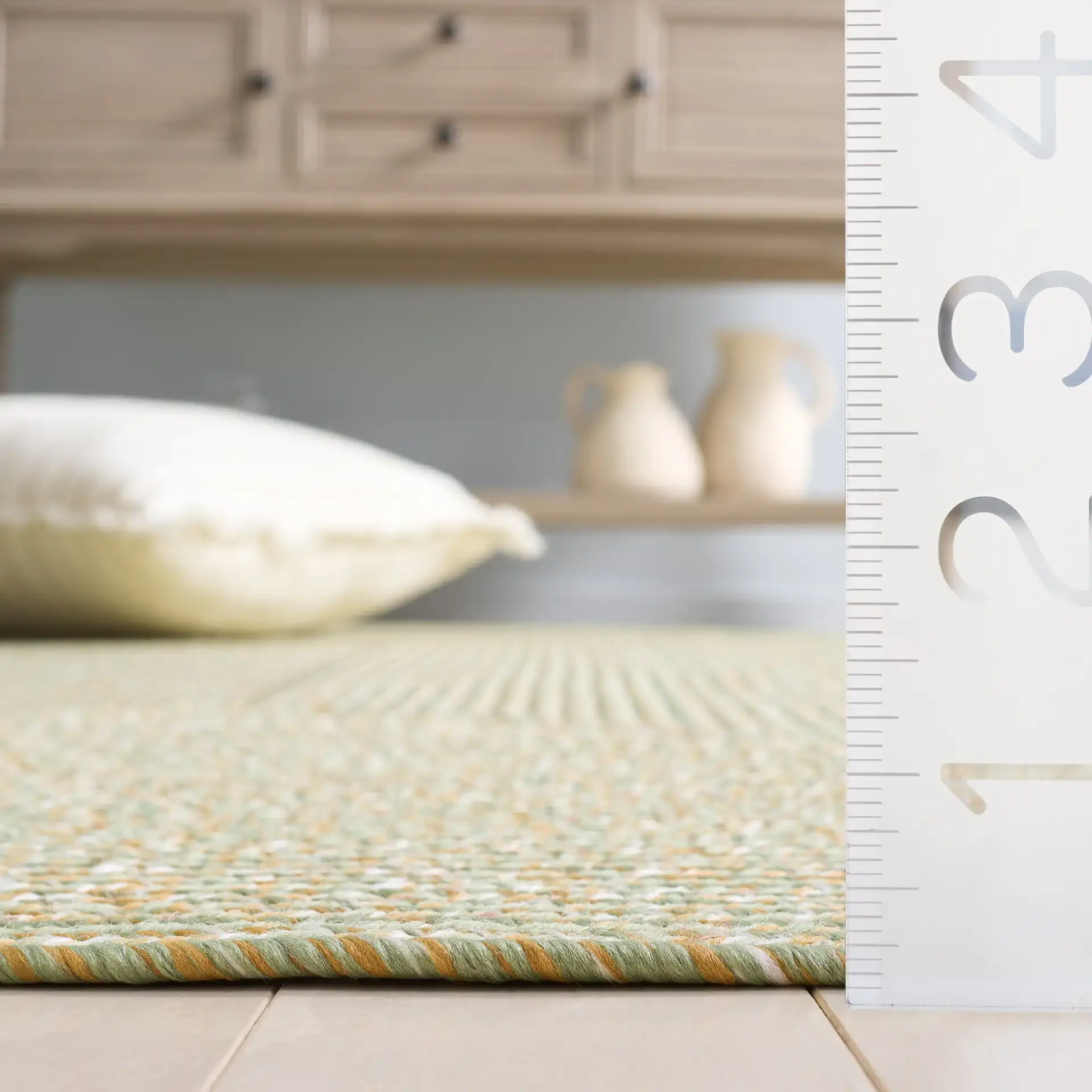 Braided Coastal Heathered Washable Outdoor Rug in Light Green / Sage in a styled room
