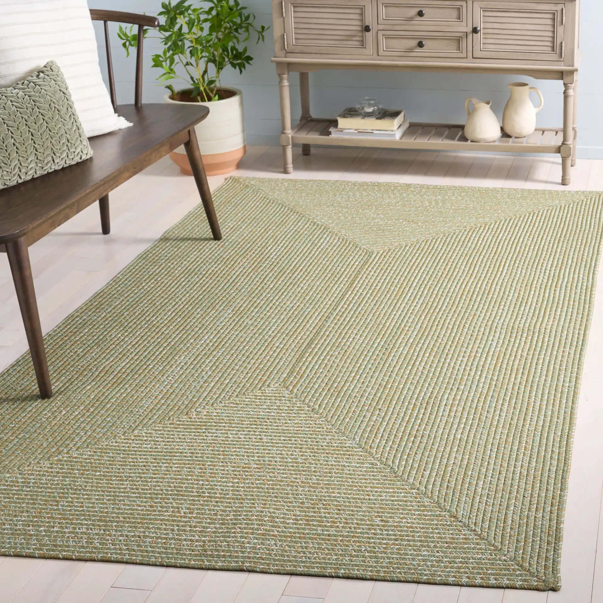 Braided Coastal Heathered Washable Outdoor Rug in Light Green / Sage in a styled room