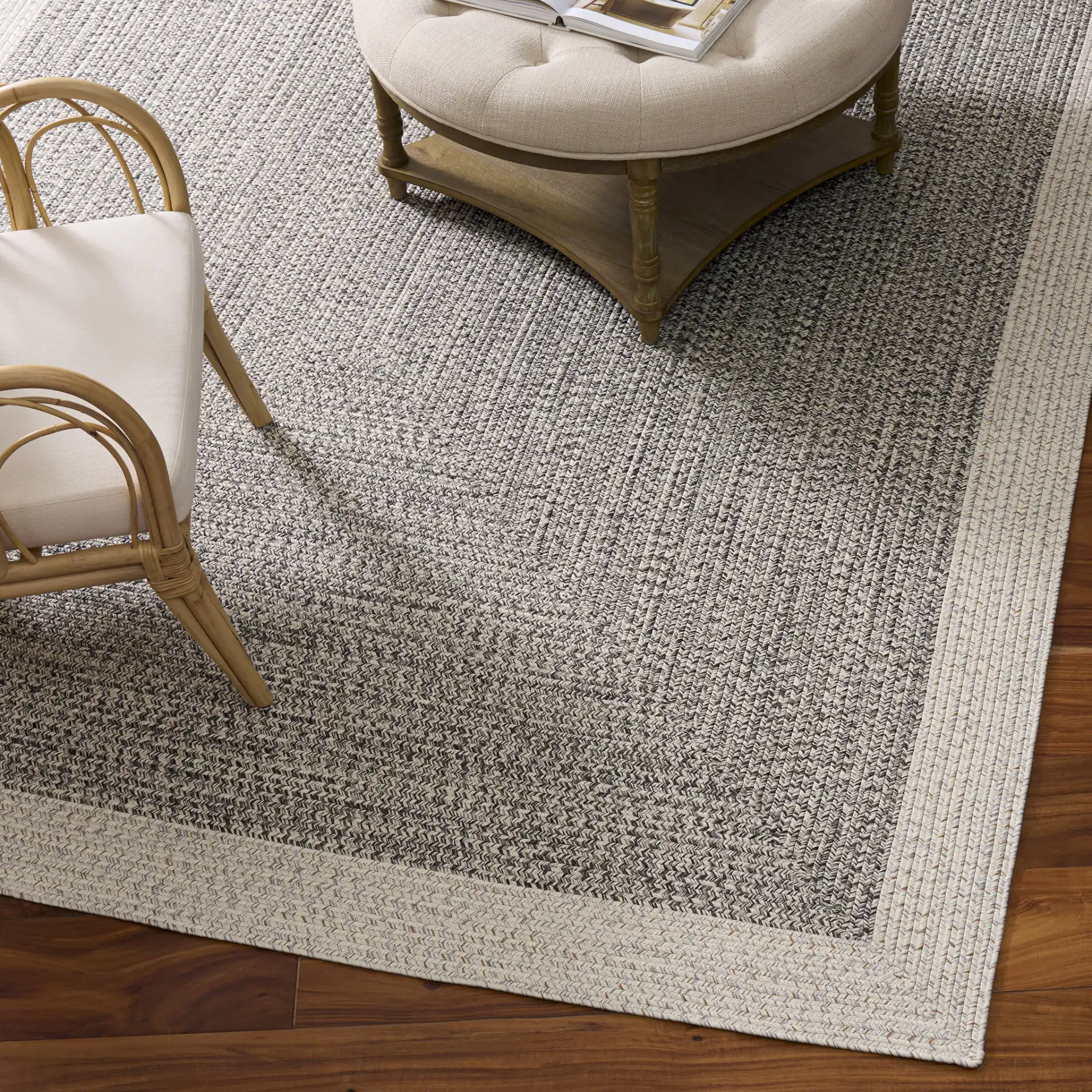 Braided Transitional Border Washable Outdoor Rug in Ivory / Gray Black in a styled room