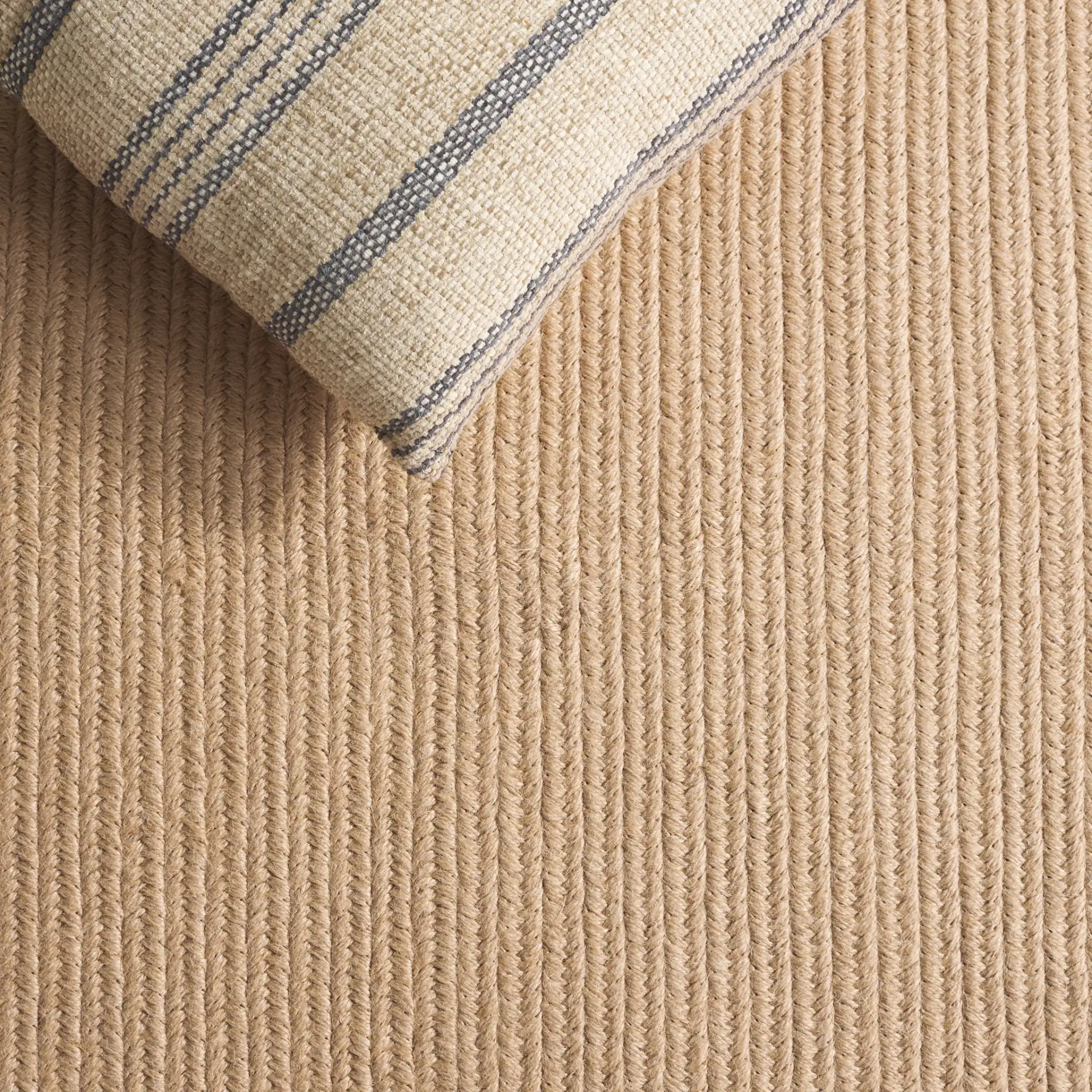 Braided Solid Oval Hand-Woven Rug in Natural in a styled room