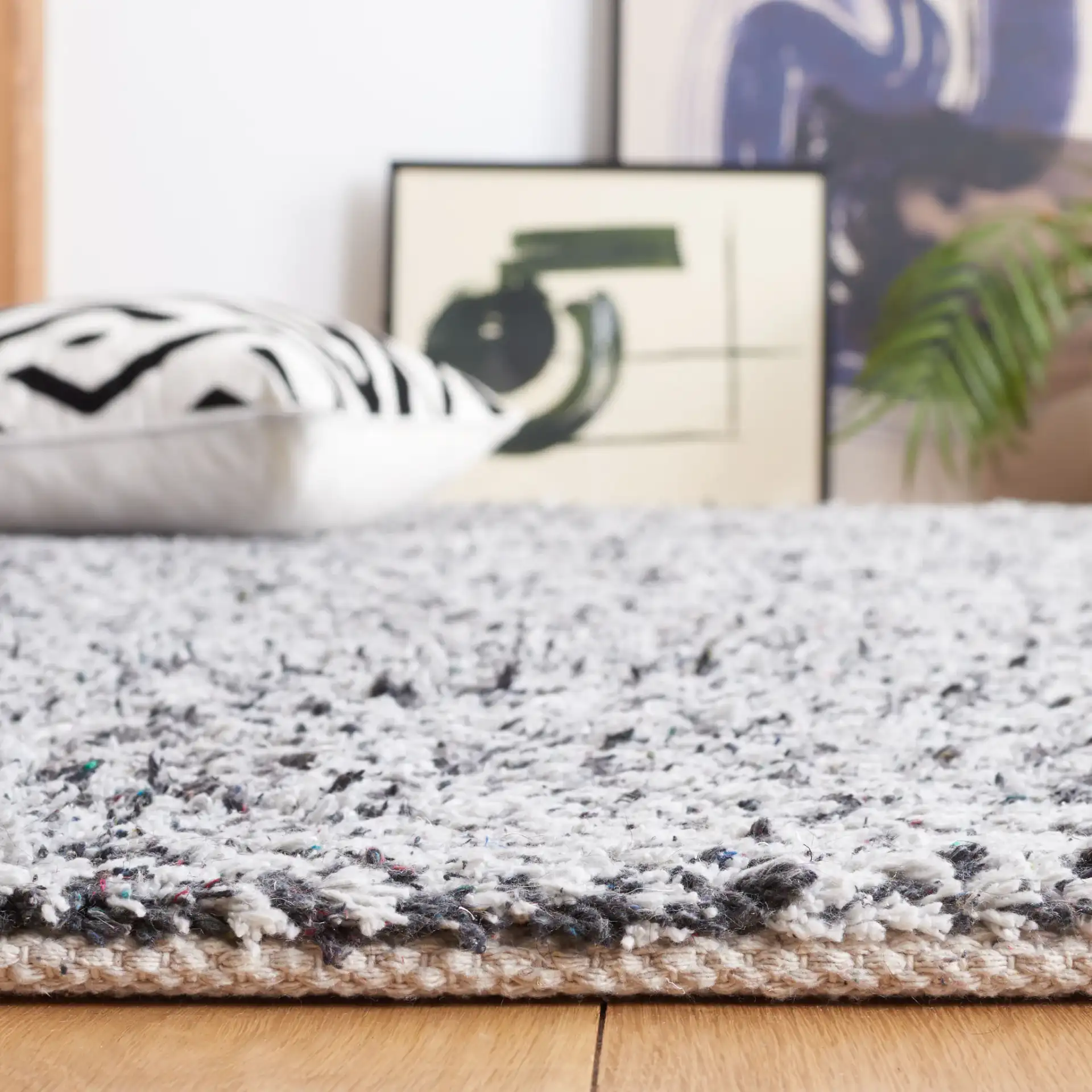 Berber Modern Solid Hand-Woven Wool Blend Rug in Ivory / Black in a styled room