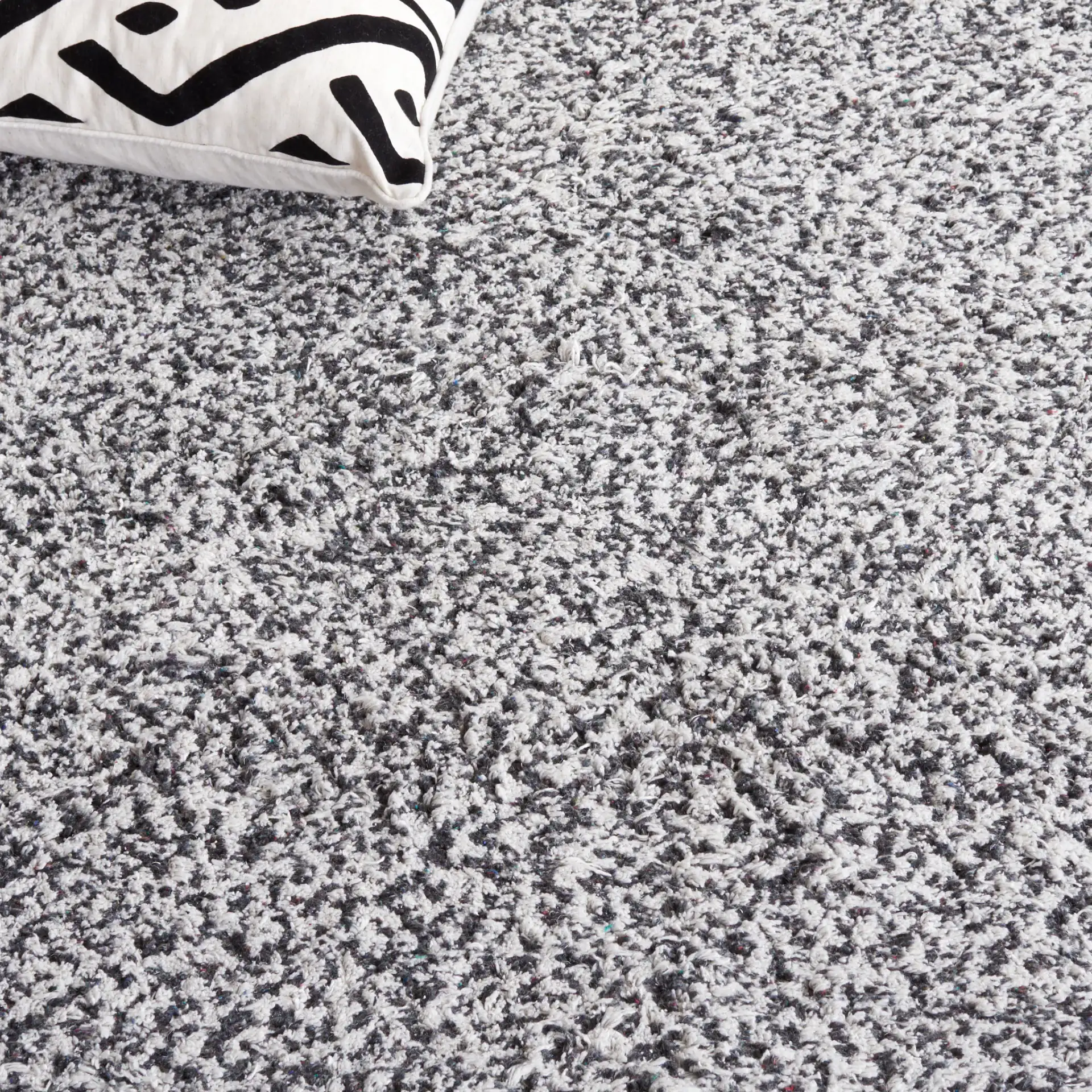 Berber Modern Solid Hand-Woven Wool Blend Rug in Ivory / Black in a styled room