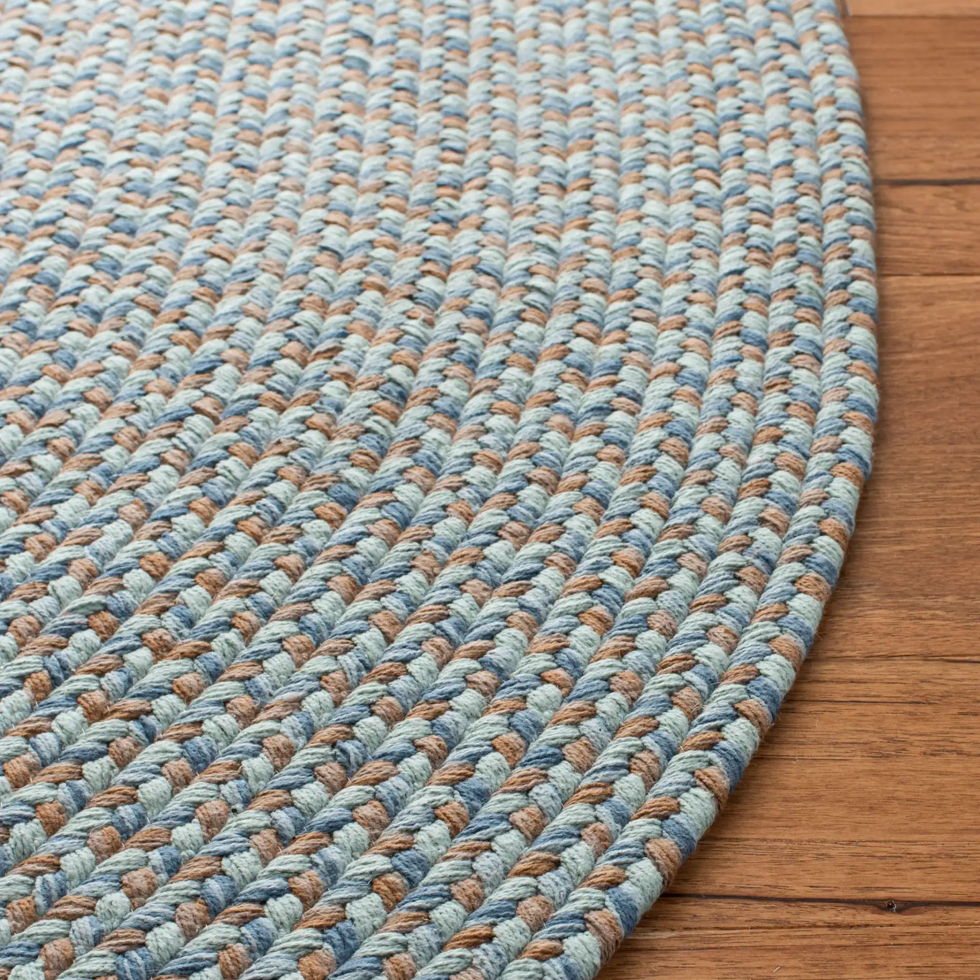 Braided Coastal Concentric Oval Hand-Woven Cotton Rug in Multicolor in a styled room