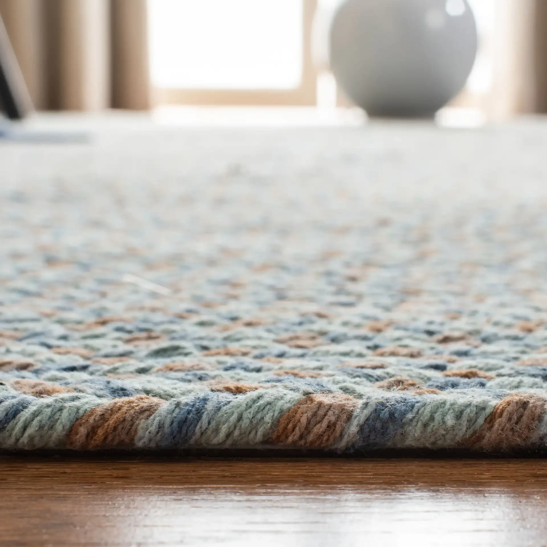 Braided Coastal Concentric Oval Hand-Woven Cotton Rug in Multicolor in a styled room